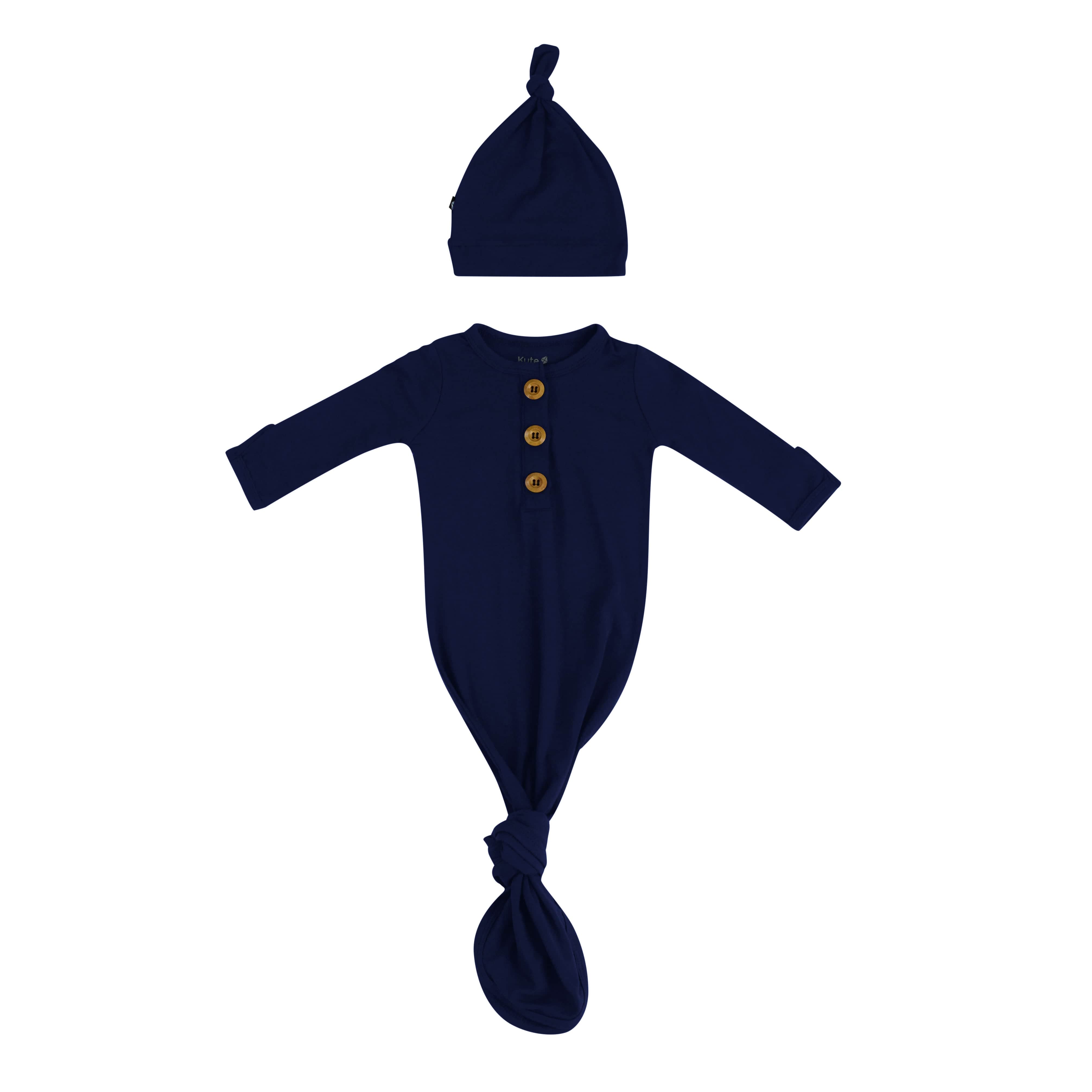 Flat lay of Kyte Baby Knotted Gown with Hat Set in Navy
