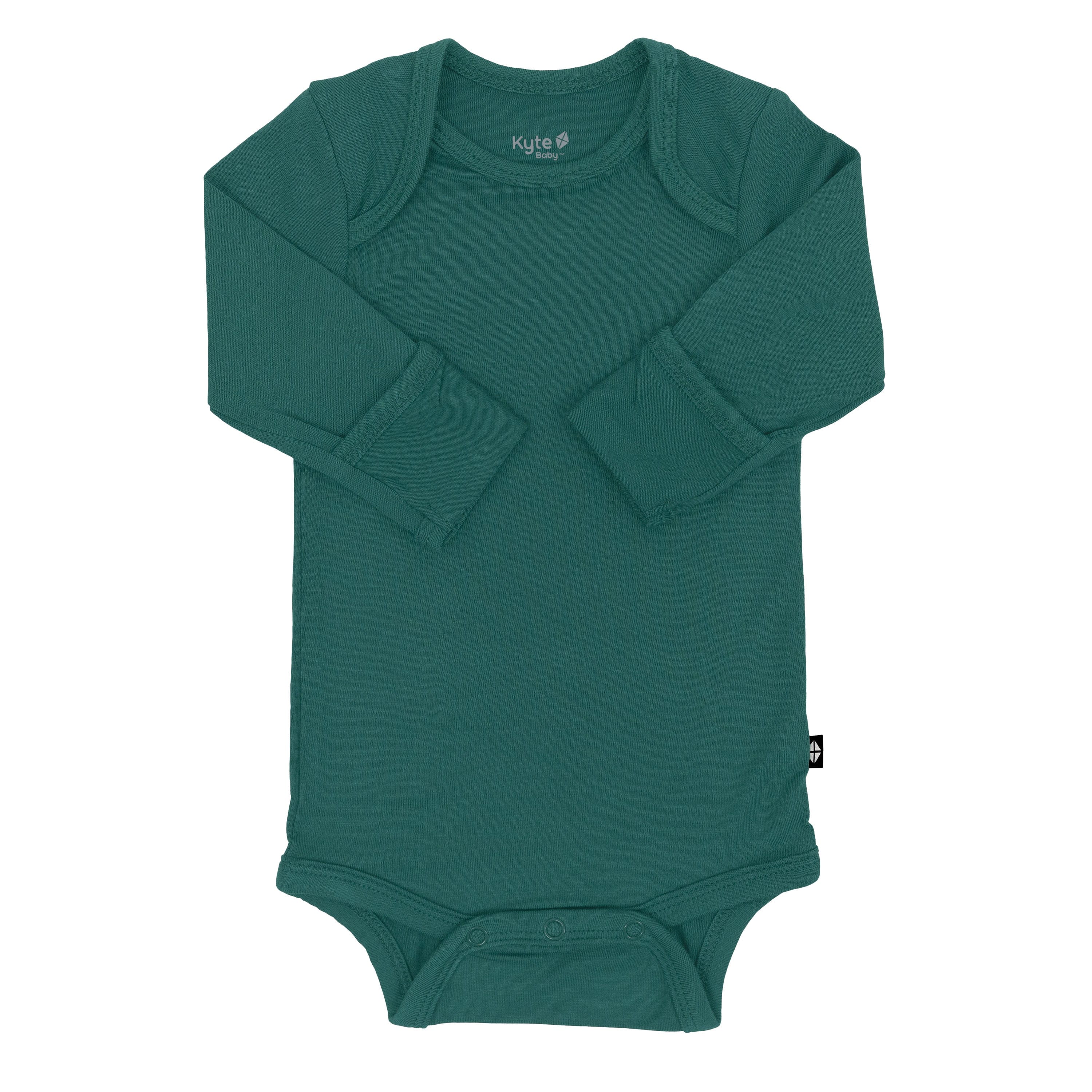 Flat lay of Kyte Baby Long Sleeve Bodysuit in Emerald with arms folded inwards and fold-over cuffs displayed