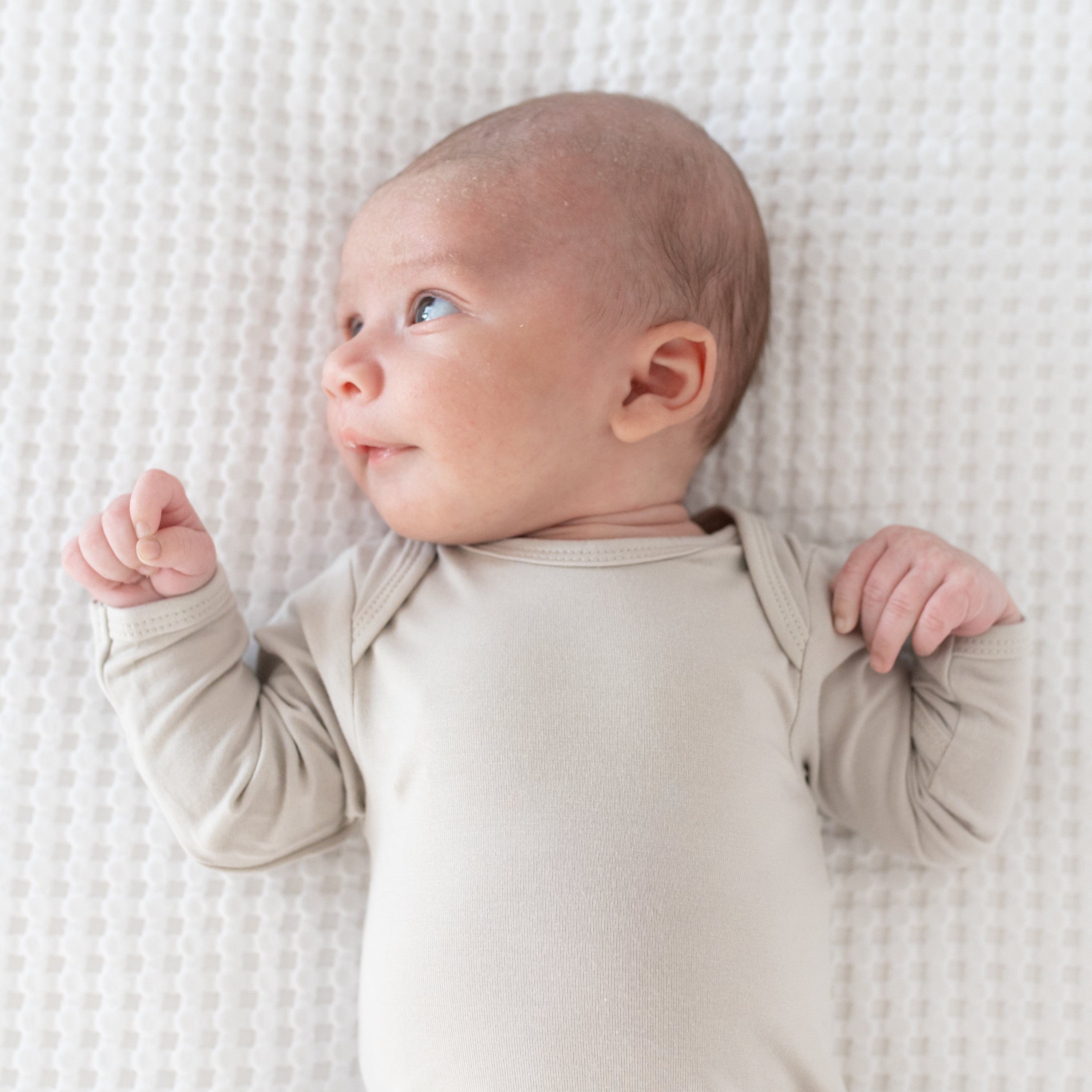 Kyte Baby Long Sleeve Bodysuit in Oat on infant