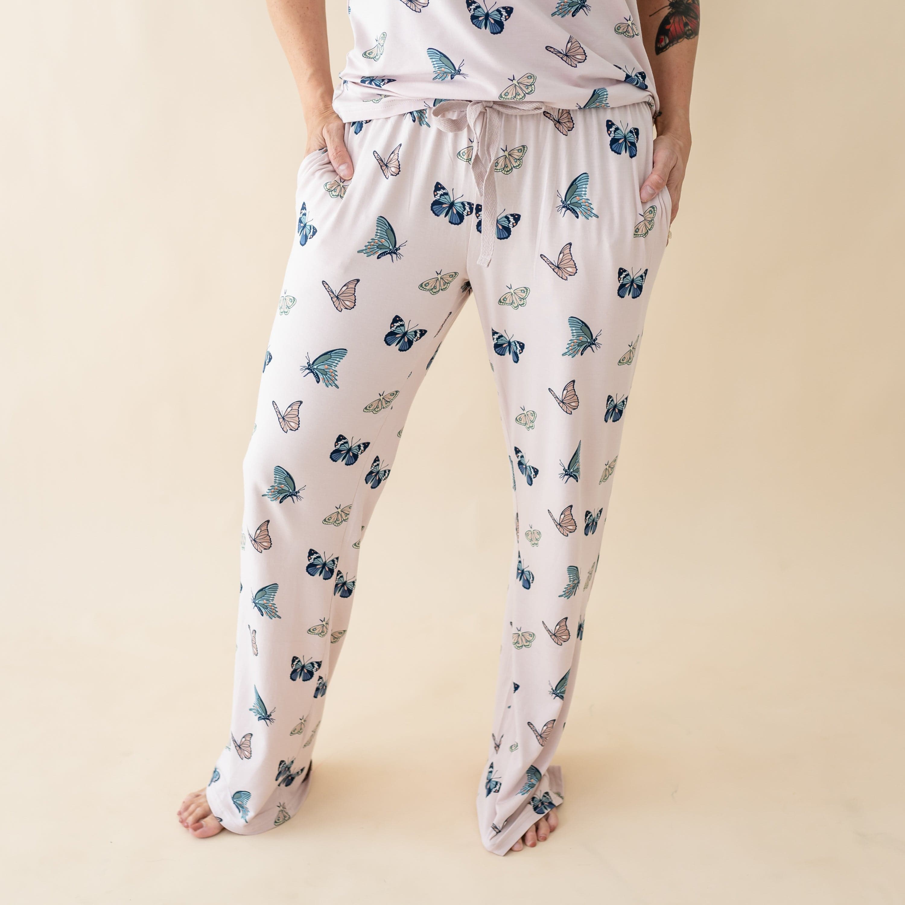 Woman wearing Kyte Baby Women's Lounge Pants in Blush Butterfly