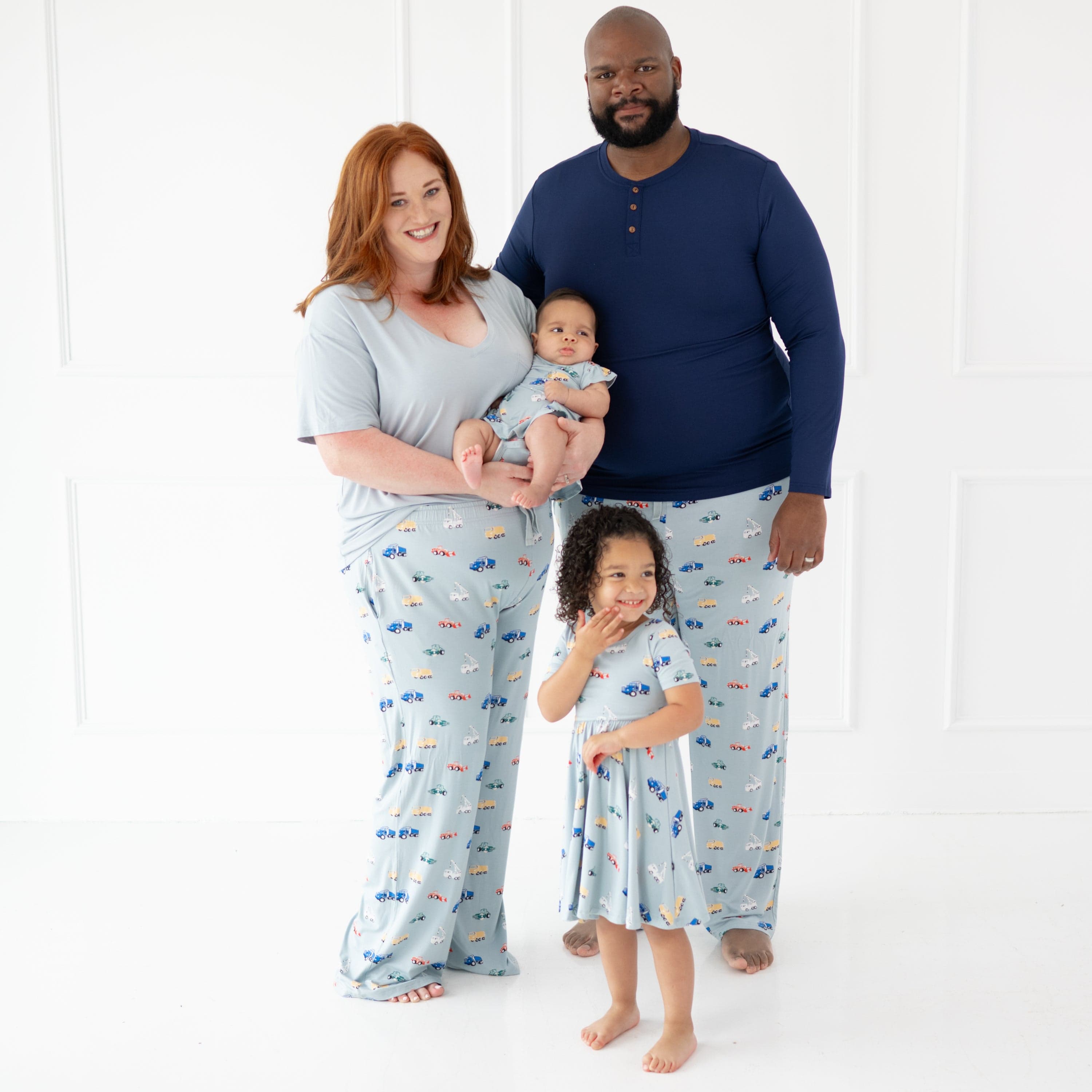 Family wearing matching Kyte Baby outfits in Construction print