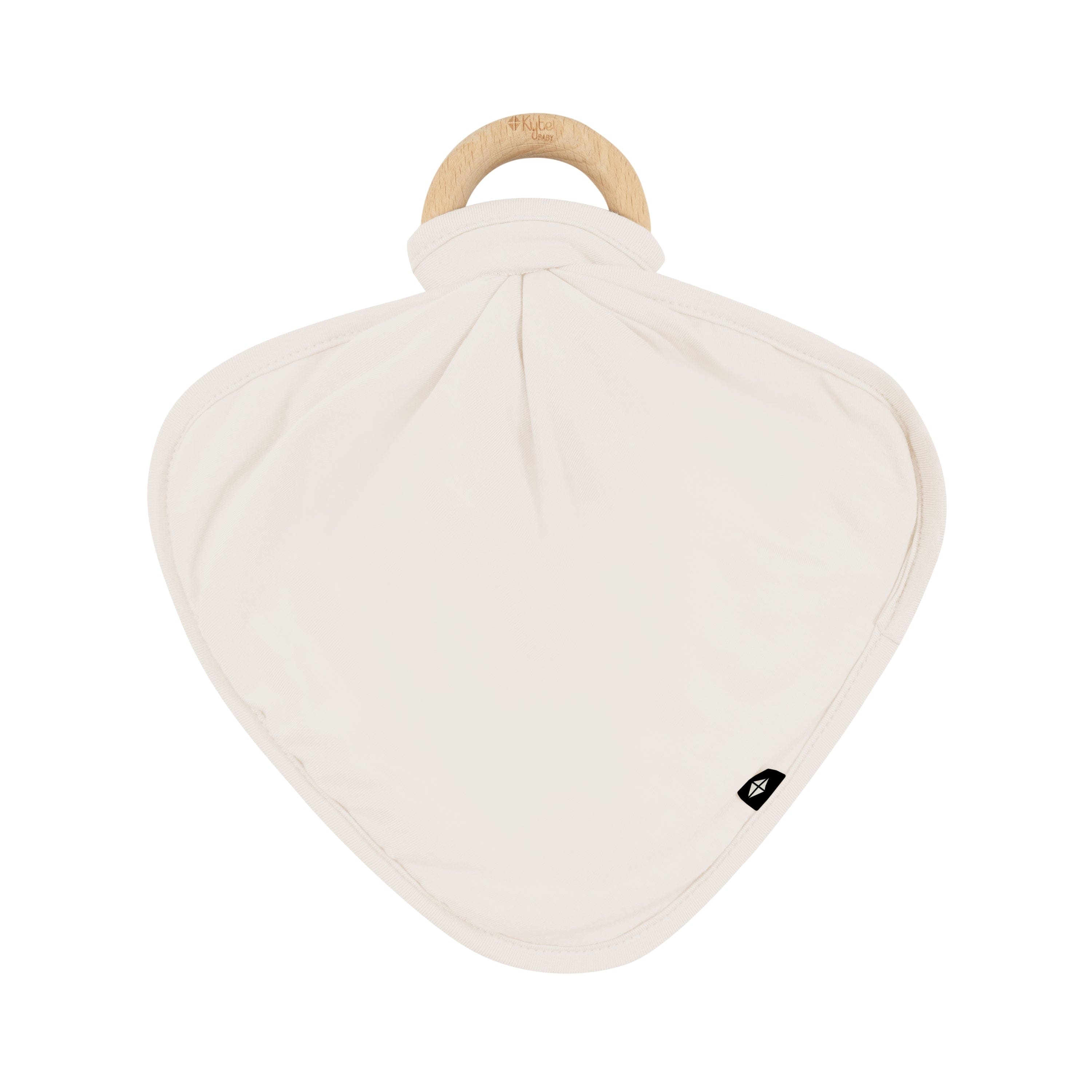 Flat lay of Kyte Baby Lovey in Oat with Removable Wooden Teething Ring
