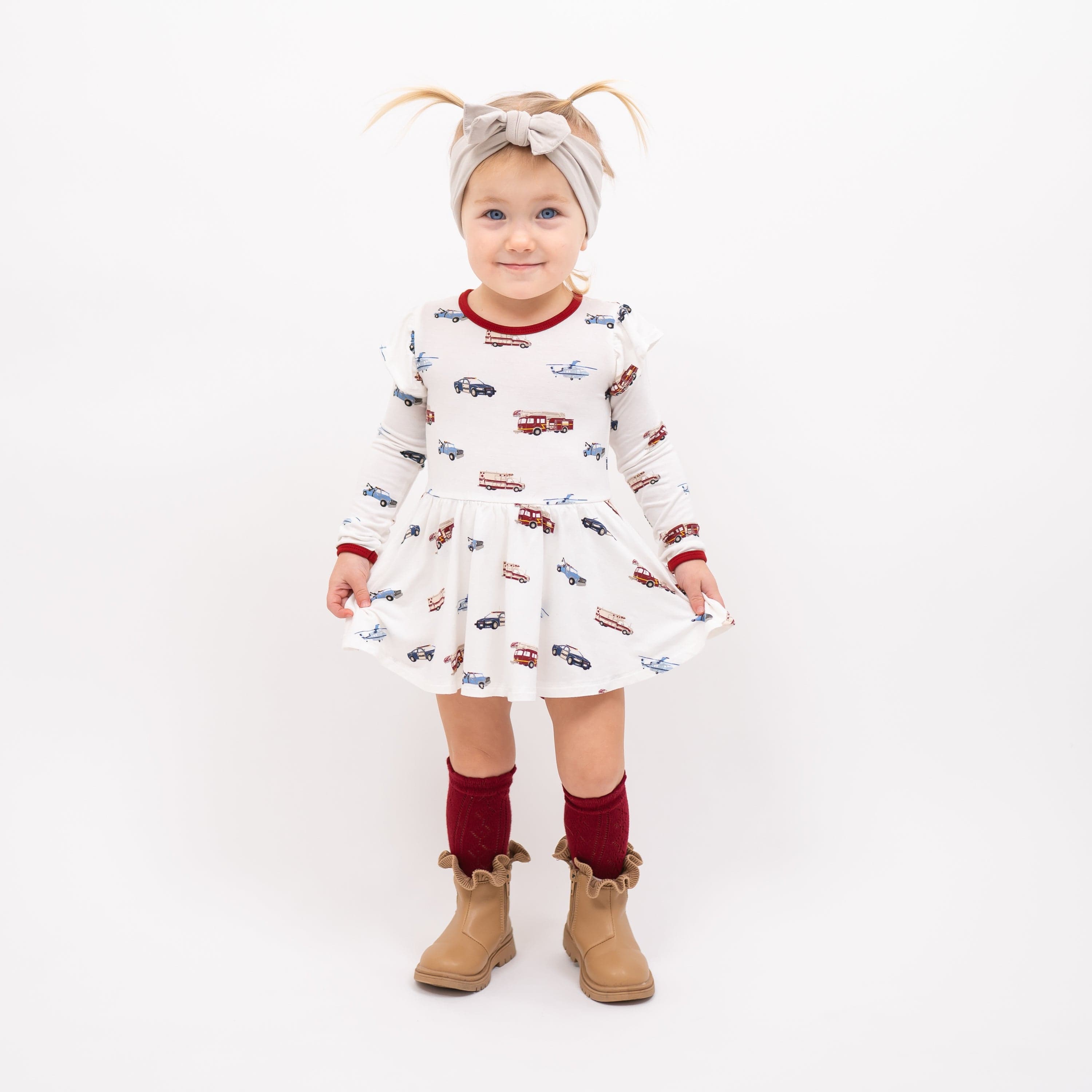 Toddler wearing Kyte Baby Twirl Bodysuit Dress in First Responder
