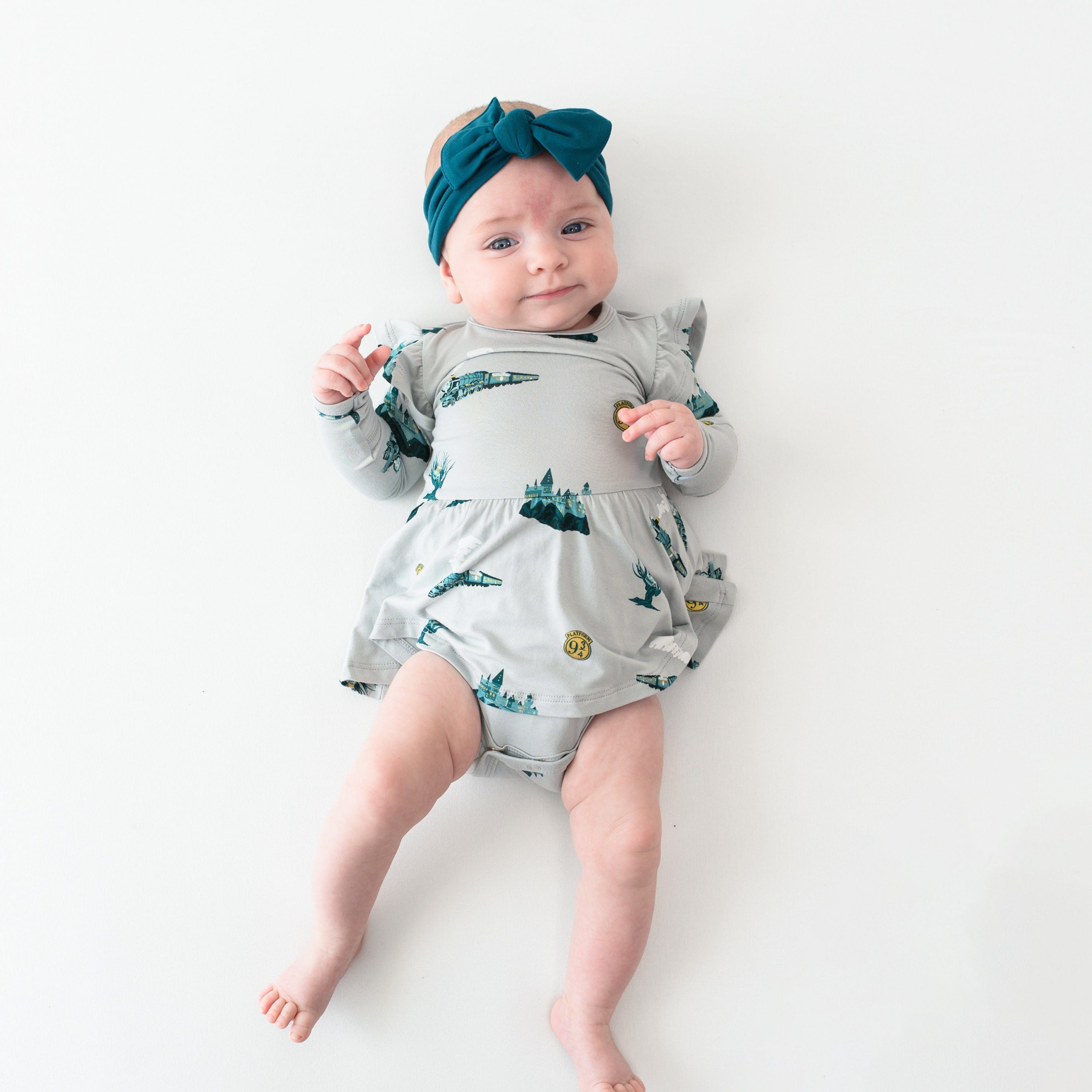 Child wearing Kyte Baby Bodysuit with Twirl Skirt in Journey