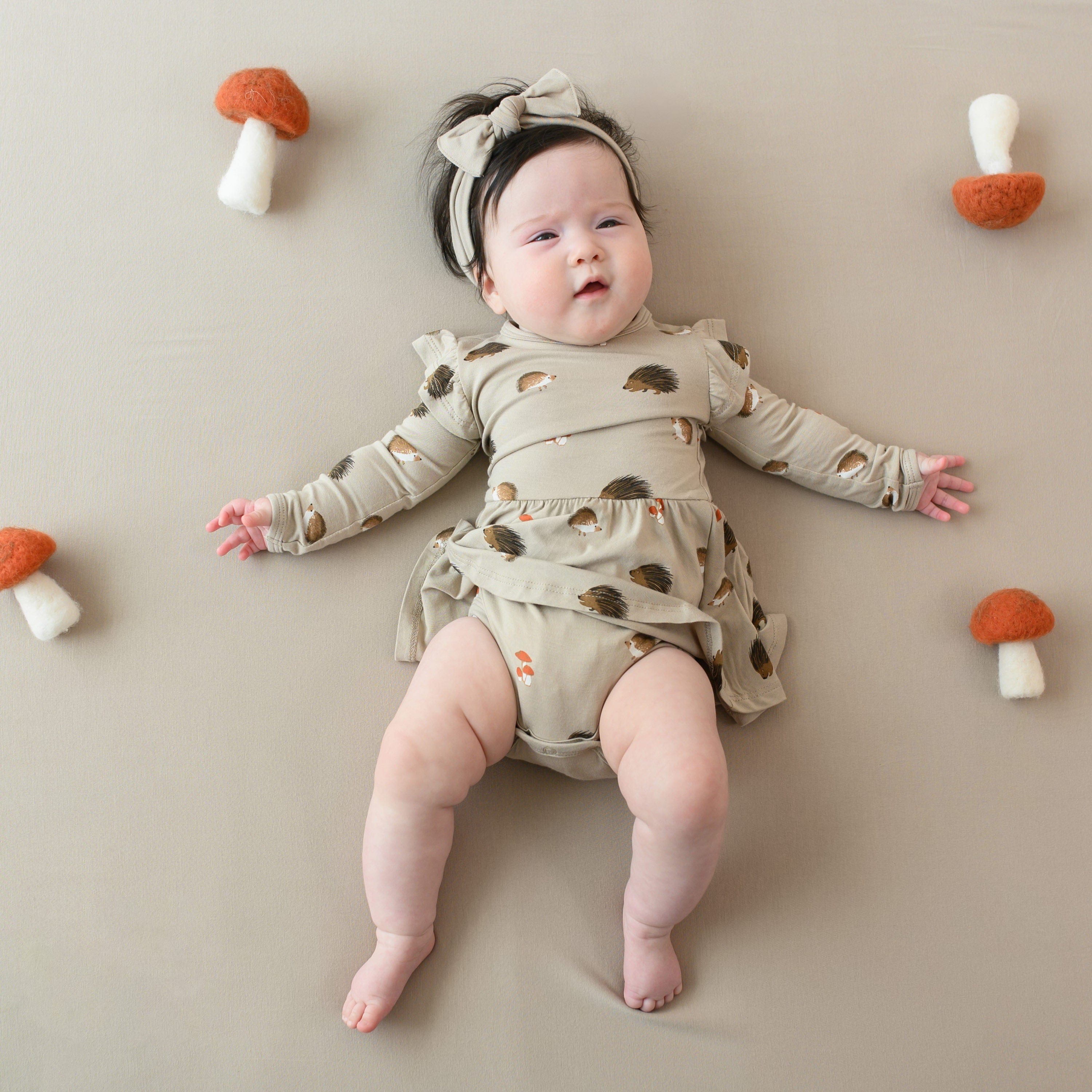 Child wearing Kyte Baby Bodysuit with Twirl Skirt in Prickle