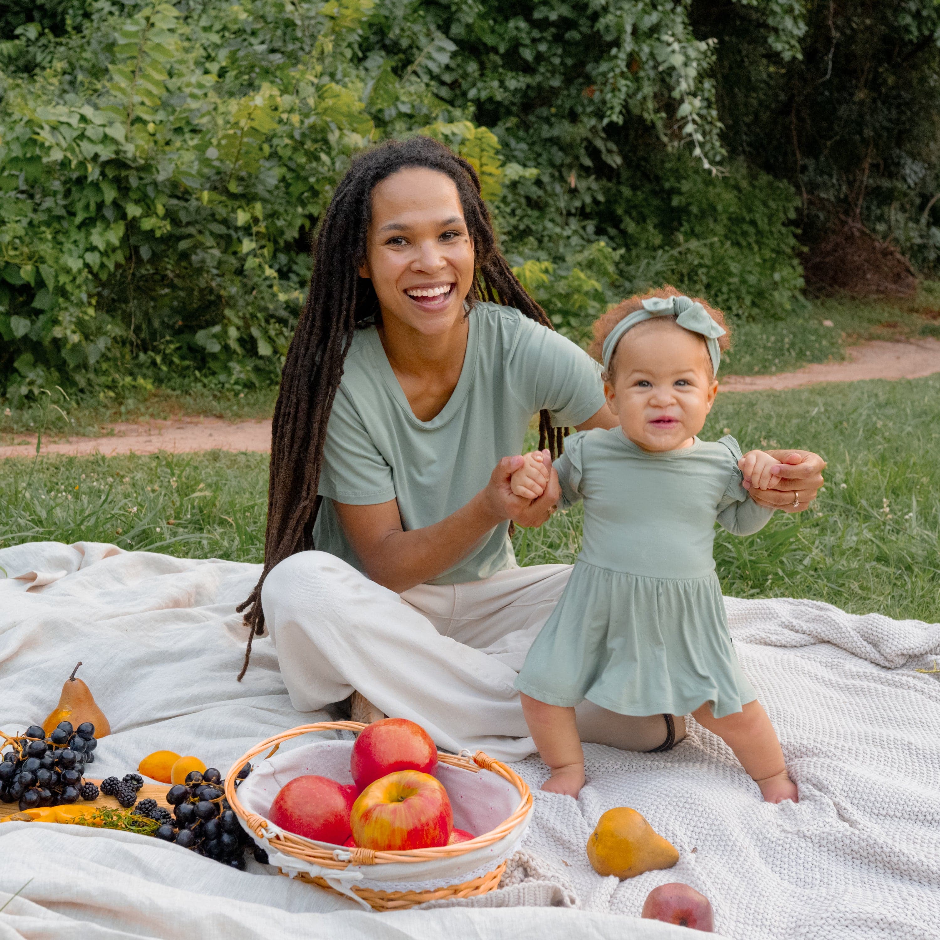 Mom in Women's Crew Neck Tee with Toddler wearing Kyte Baby Bodysuit with Twirl Skirt in Thyme