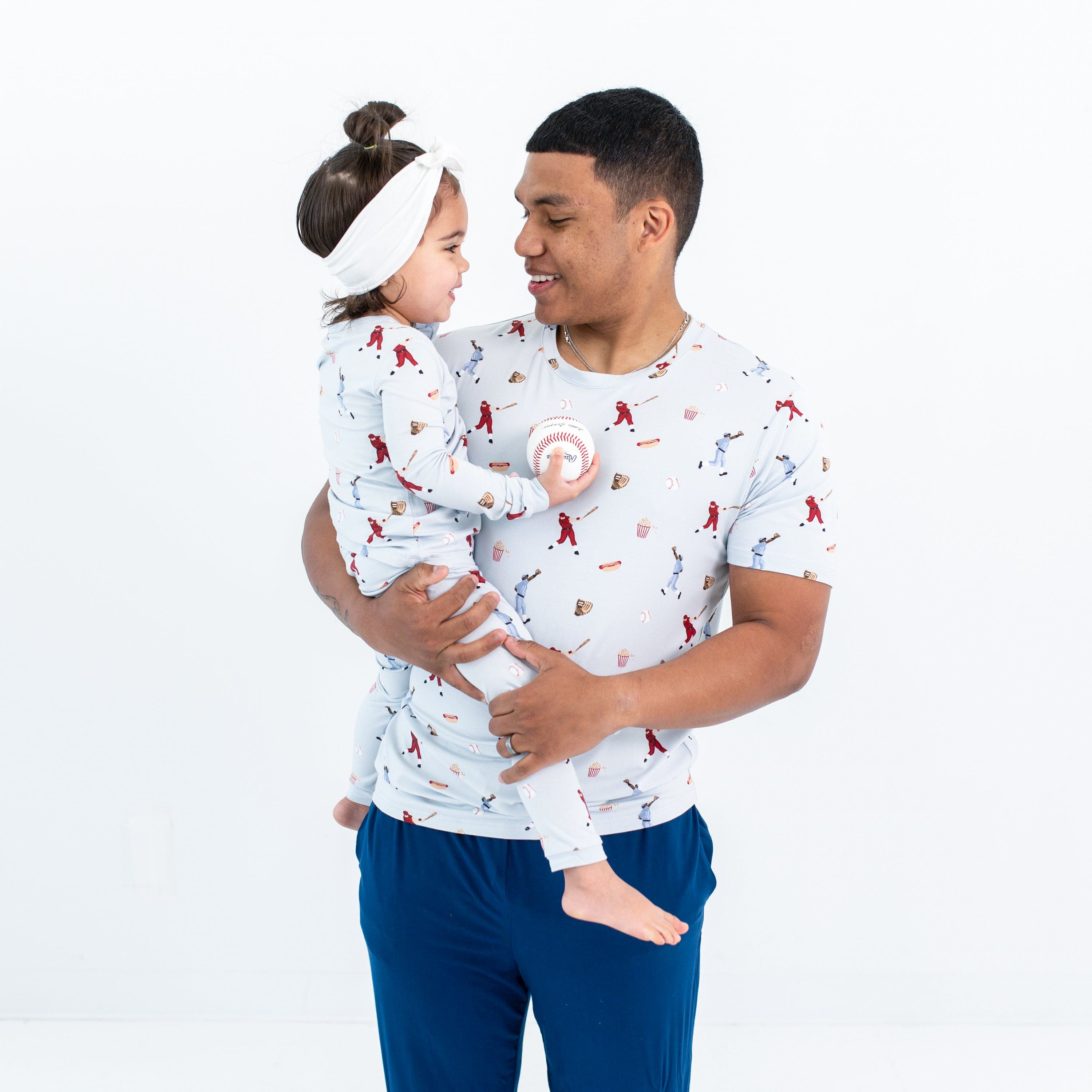 Dad and daughter in Kyte Baby matching family outfits in Vintage Baseball