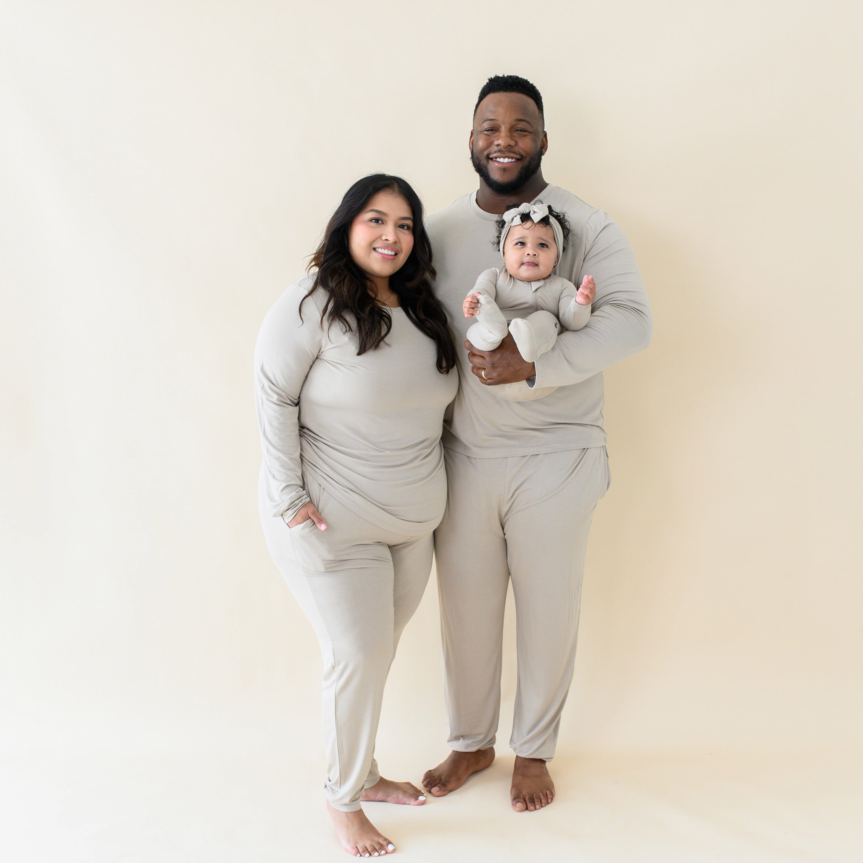 Family wearing matching Kyte Baby pajamas Almond
