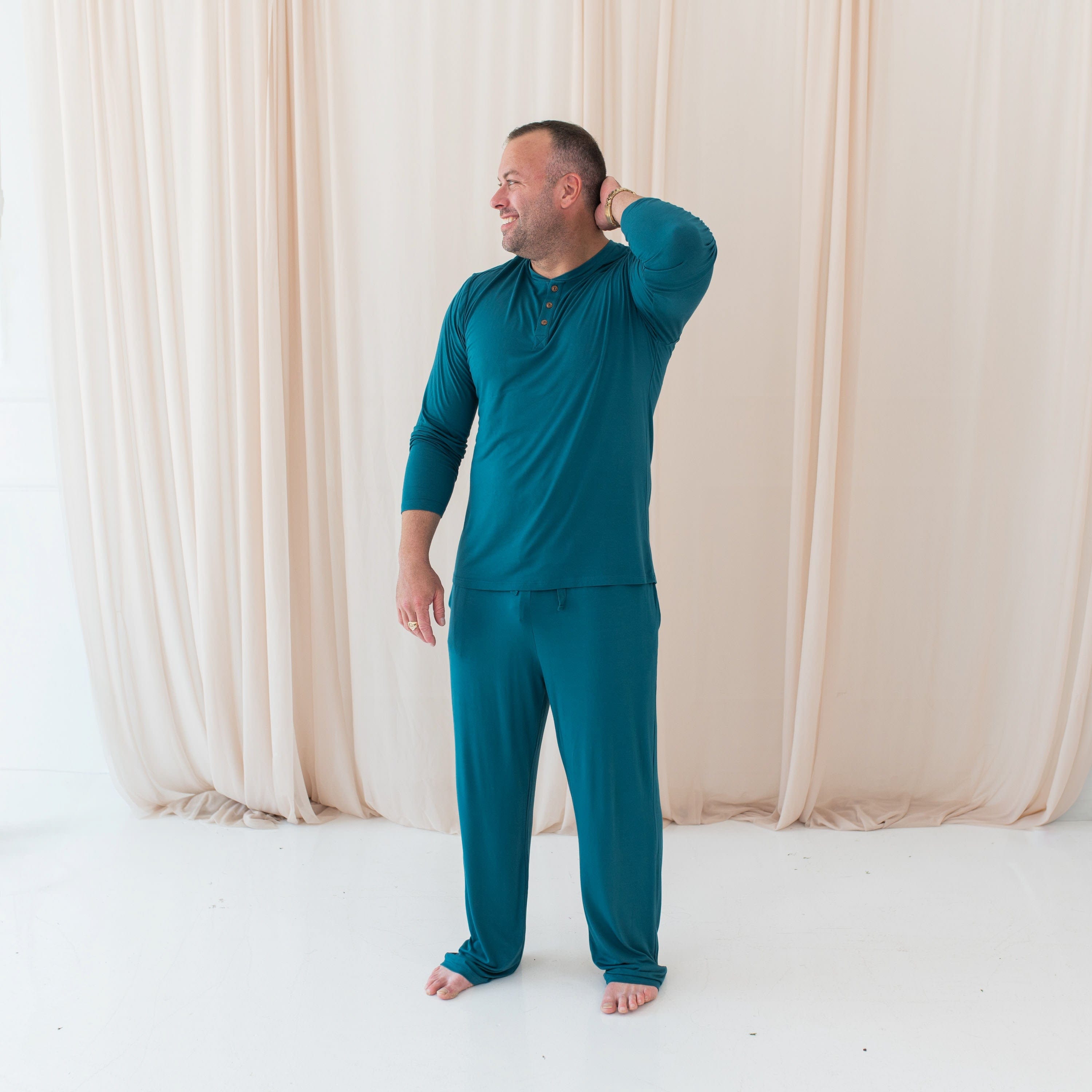 Man wearing Kyte Baby Men's Lounge Pants and Henley Top in Loch