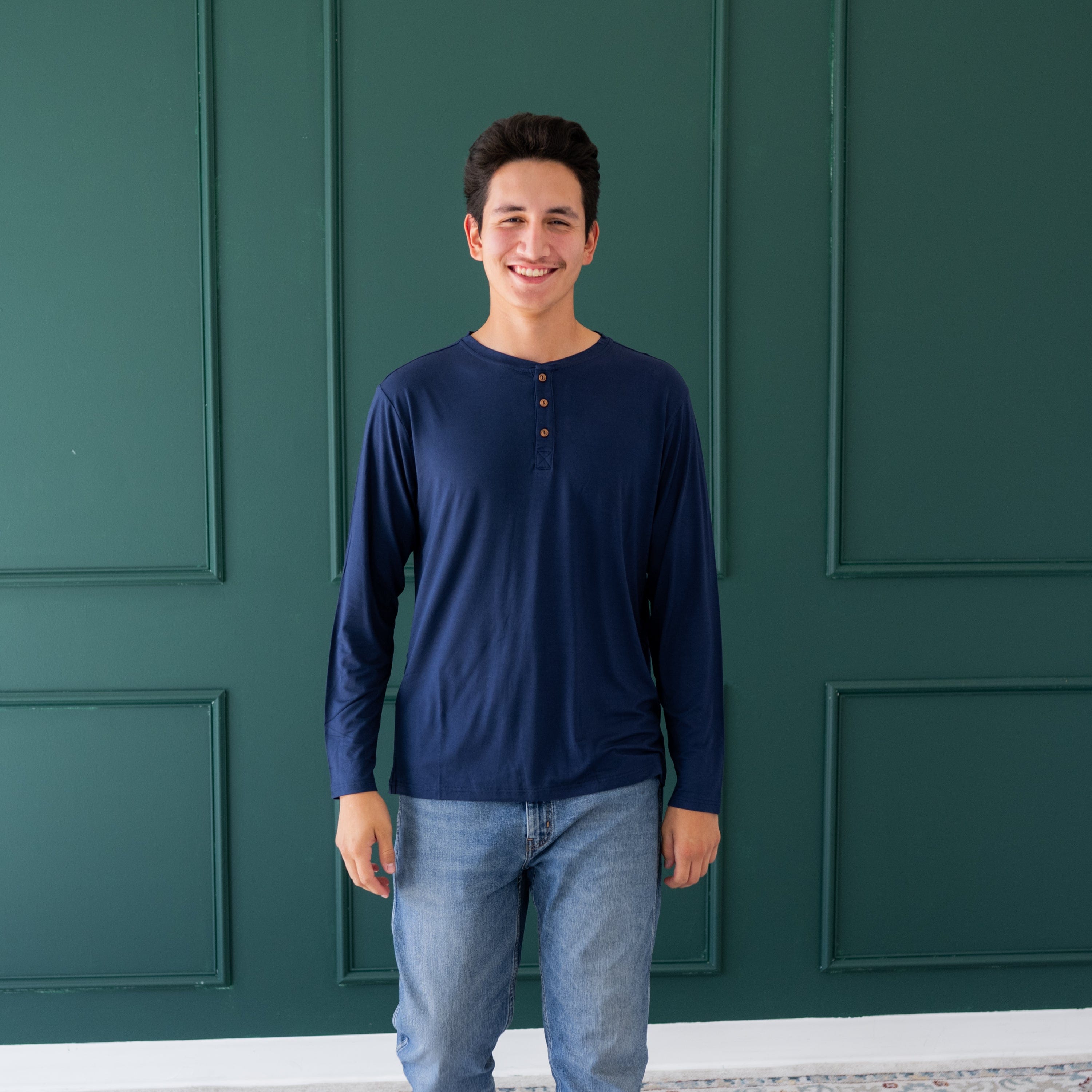 Man wearing Kyte Baby Men's Long Sleeve Henley Top in Navy
