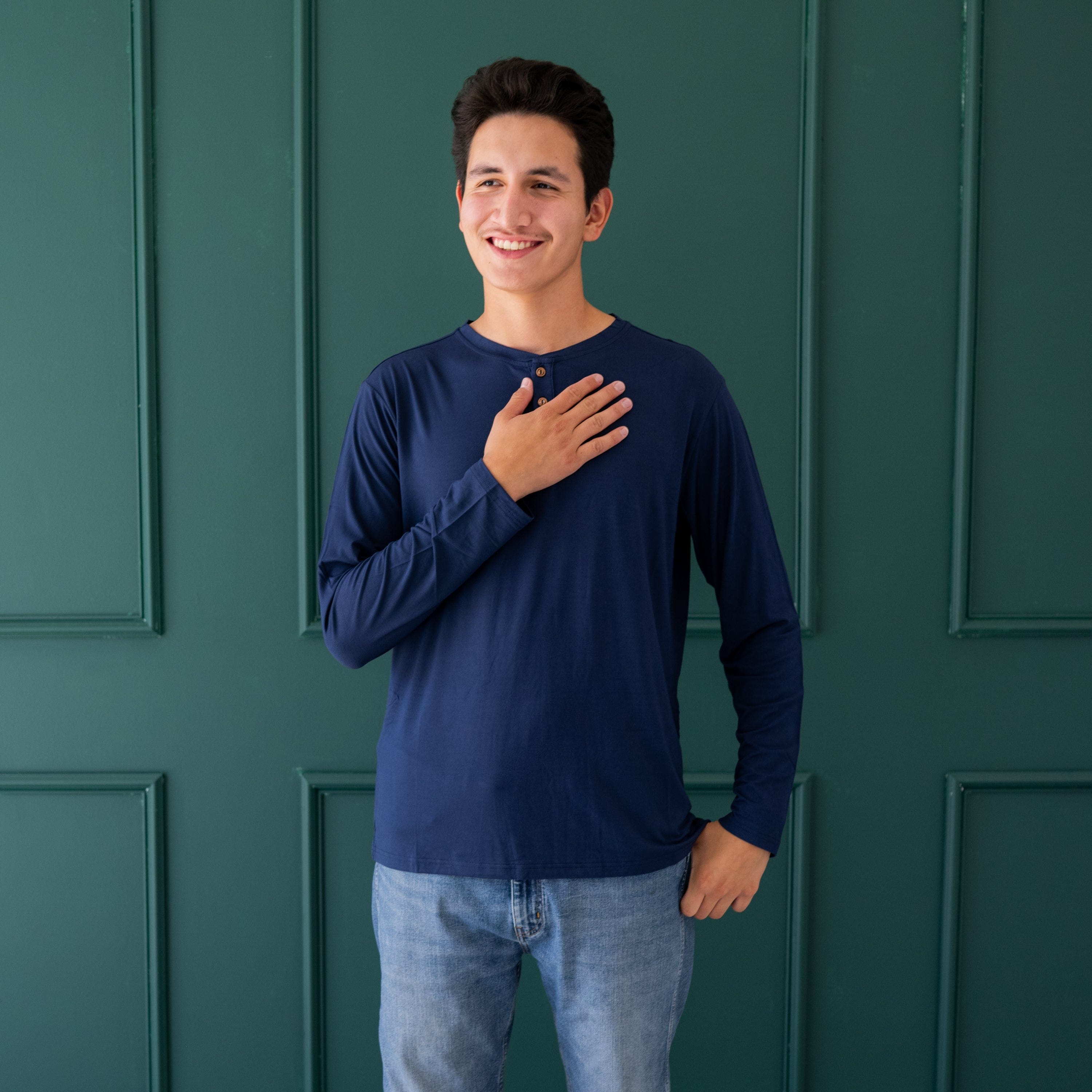 Man wearing Kyte Baby Long Sleeve Henley Top with wood buttons in Navy blue