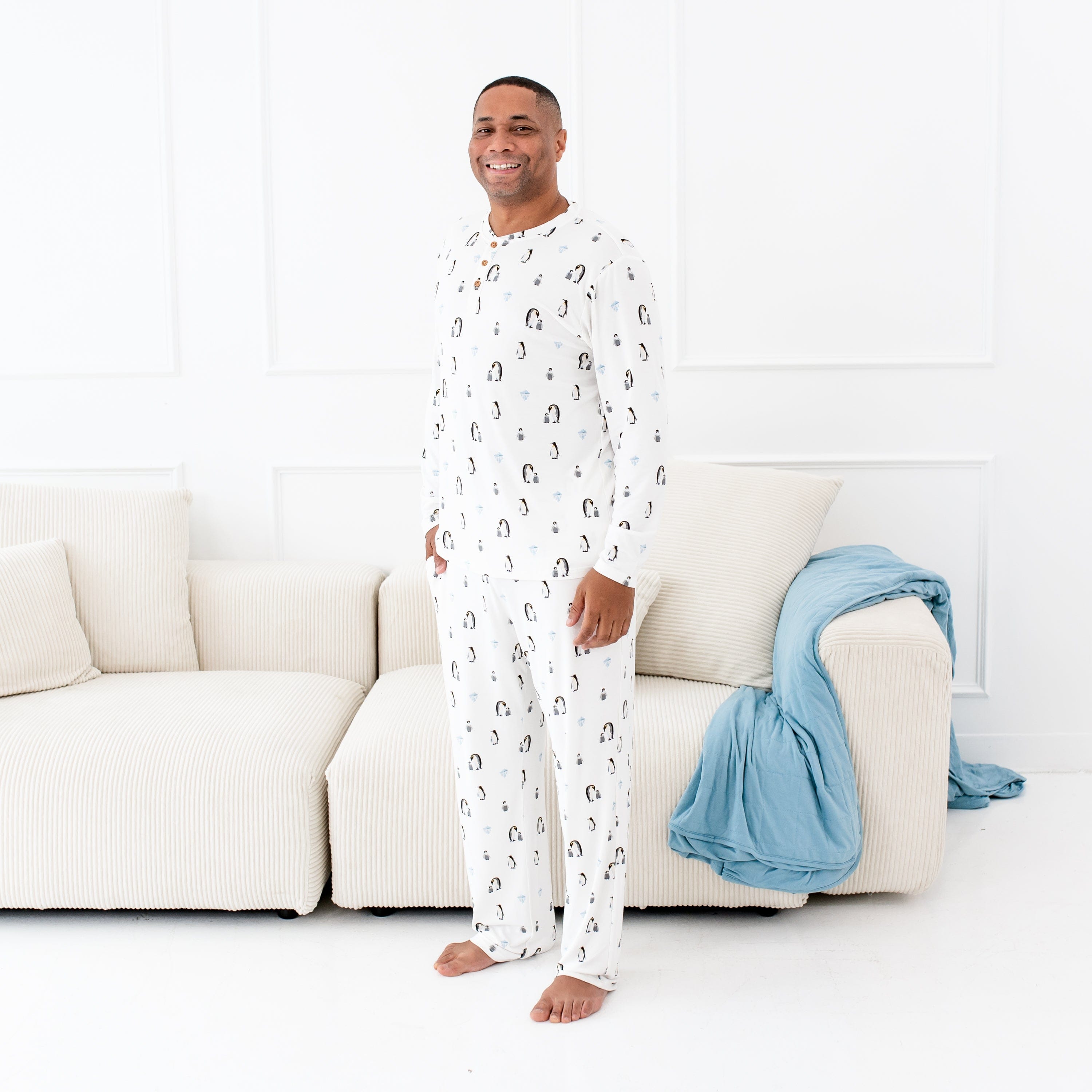 Man wearing Kyte Baby Men's Lounge Pants in Penguin