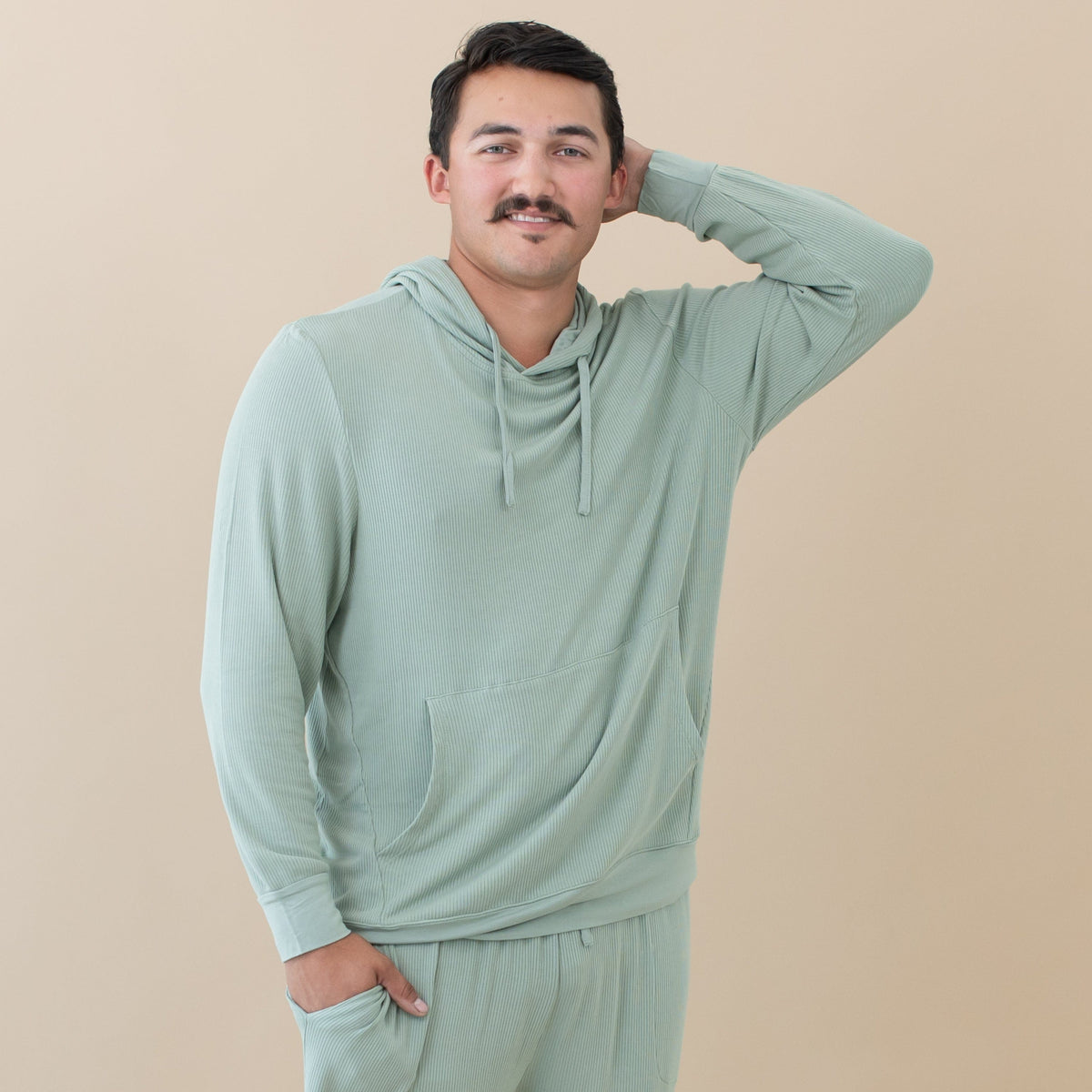 Man wearing Kyte Baby Men's Ribbed Hoodie in Thyme