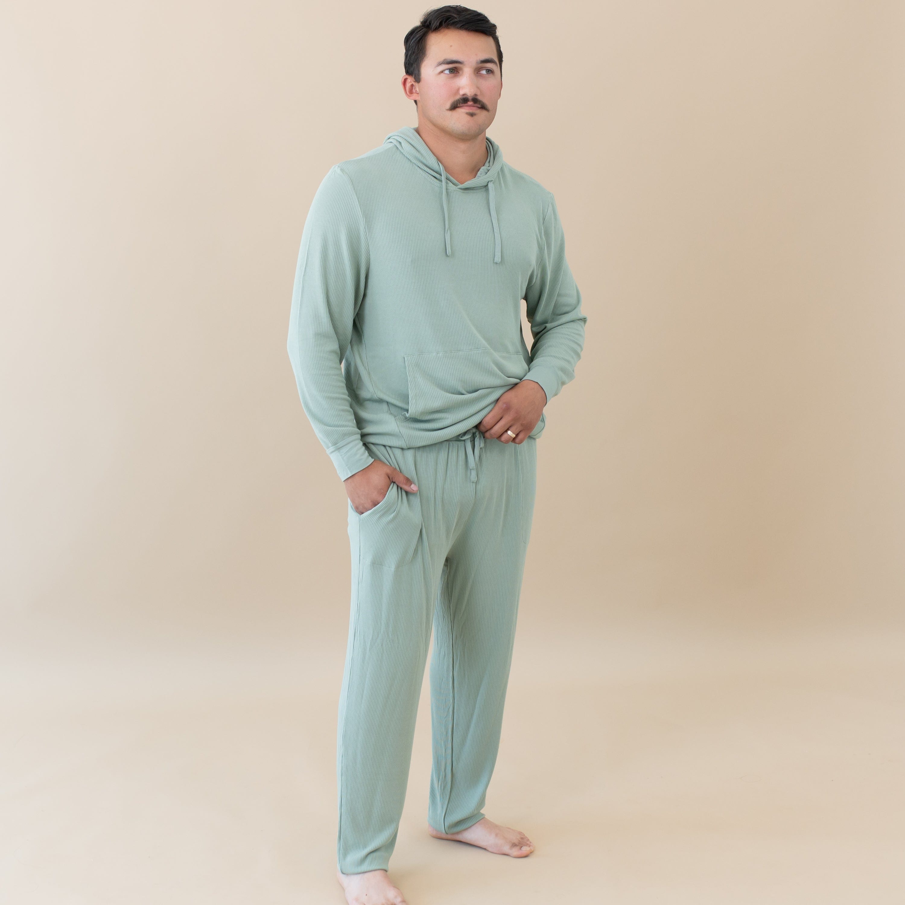 Man wearing Kyte Baby Men's Ribbed Jogger Pant with Hoodie in Thyme