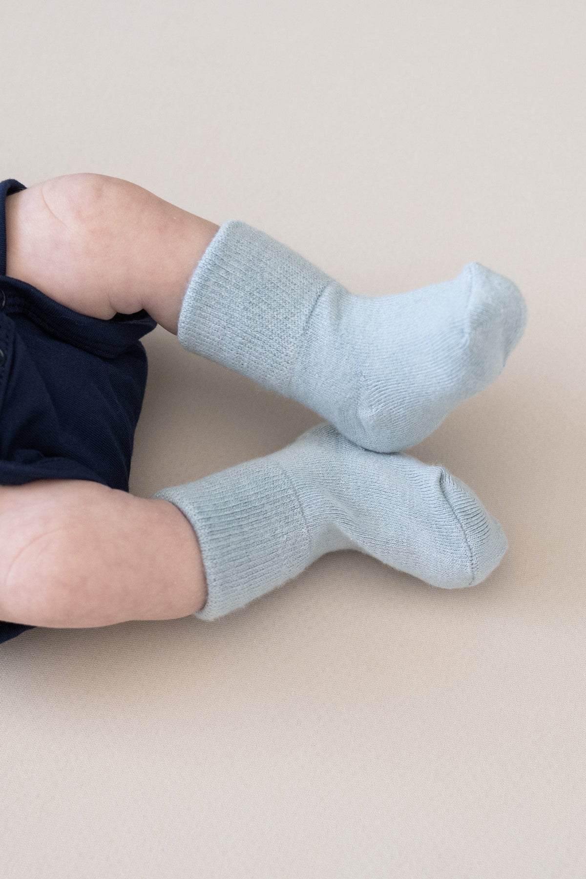 Newborn wearing Kyte Baby Quarter Socks in Cool Blue