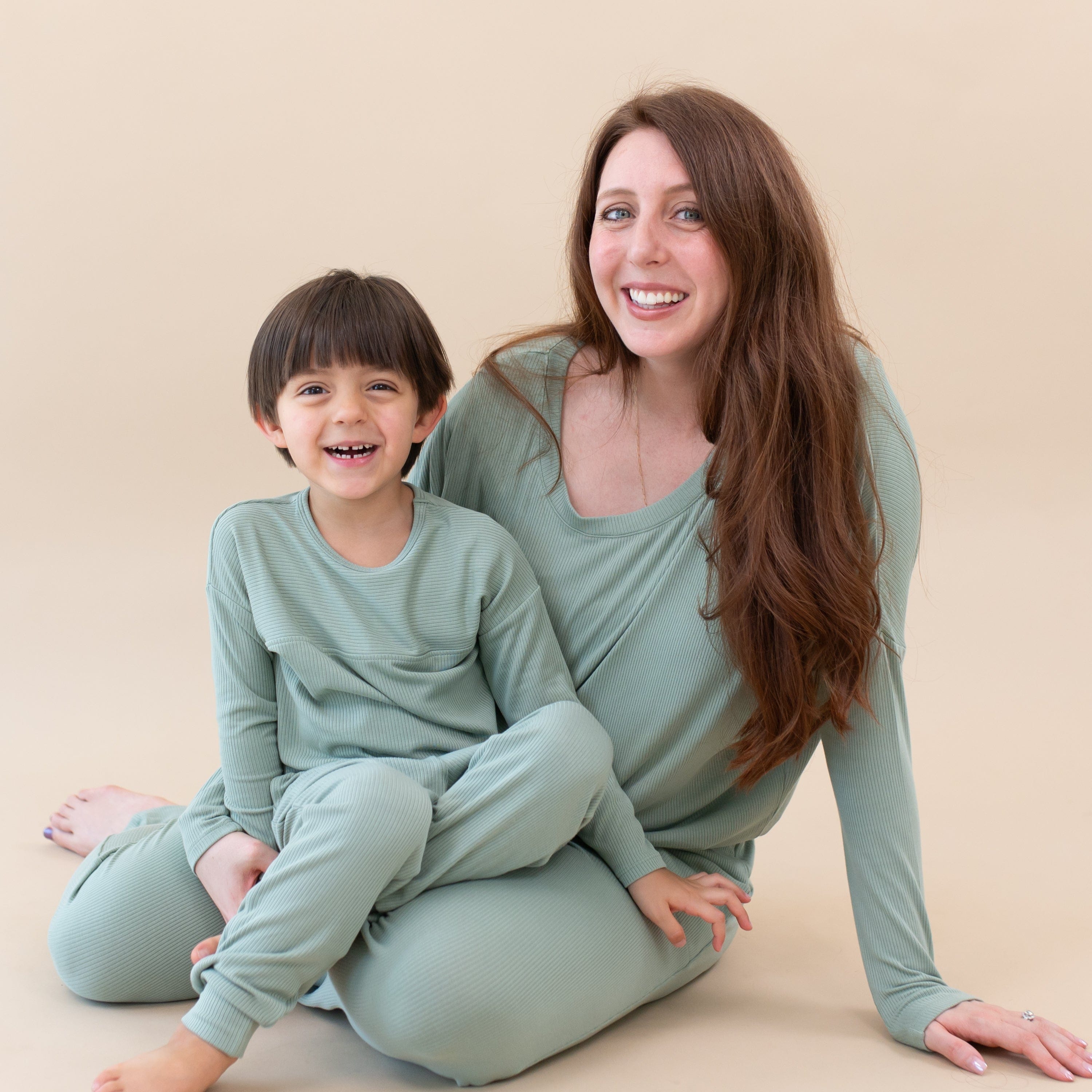 Toddler wearing Kyte Baby Bamboo Ribbed Drop Shoulder Top in Thyme with mom wearing matching set