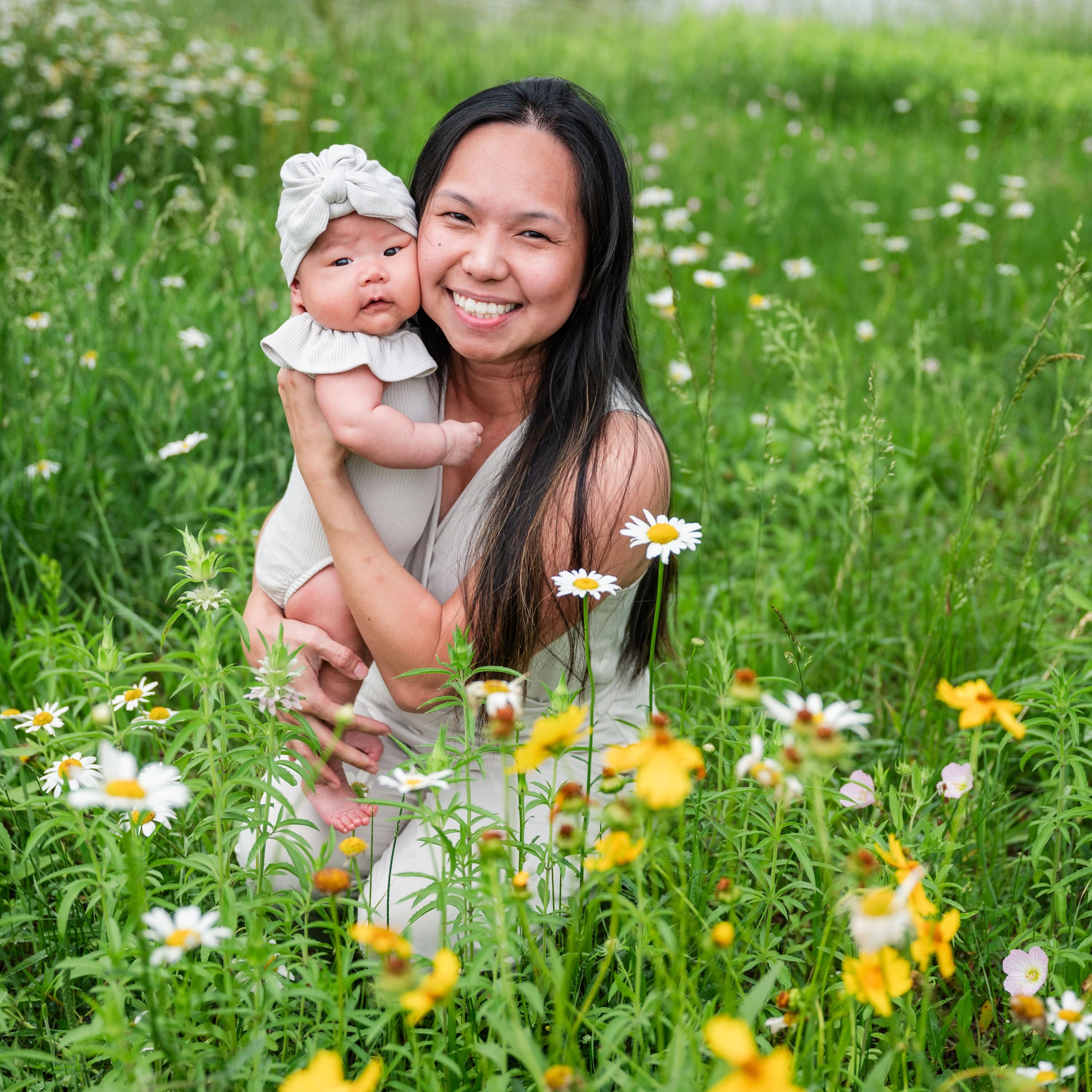 Mom holding newborn wearing Kyte Baby Ribbed Headwrap in Oat