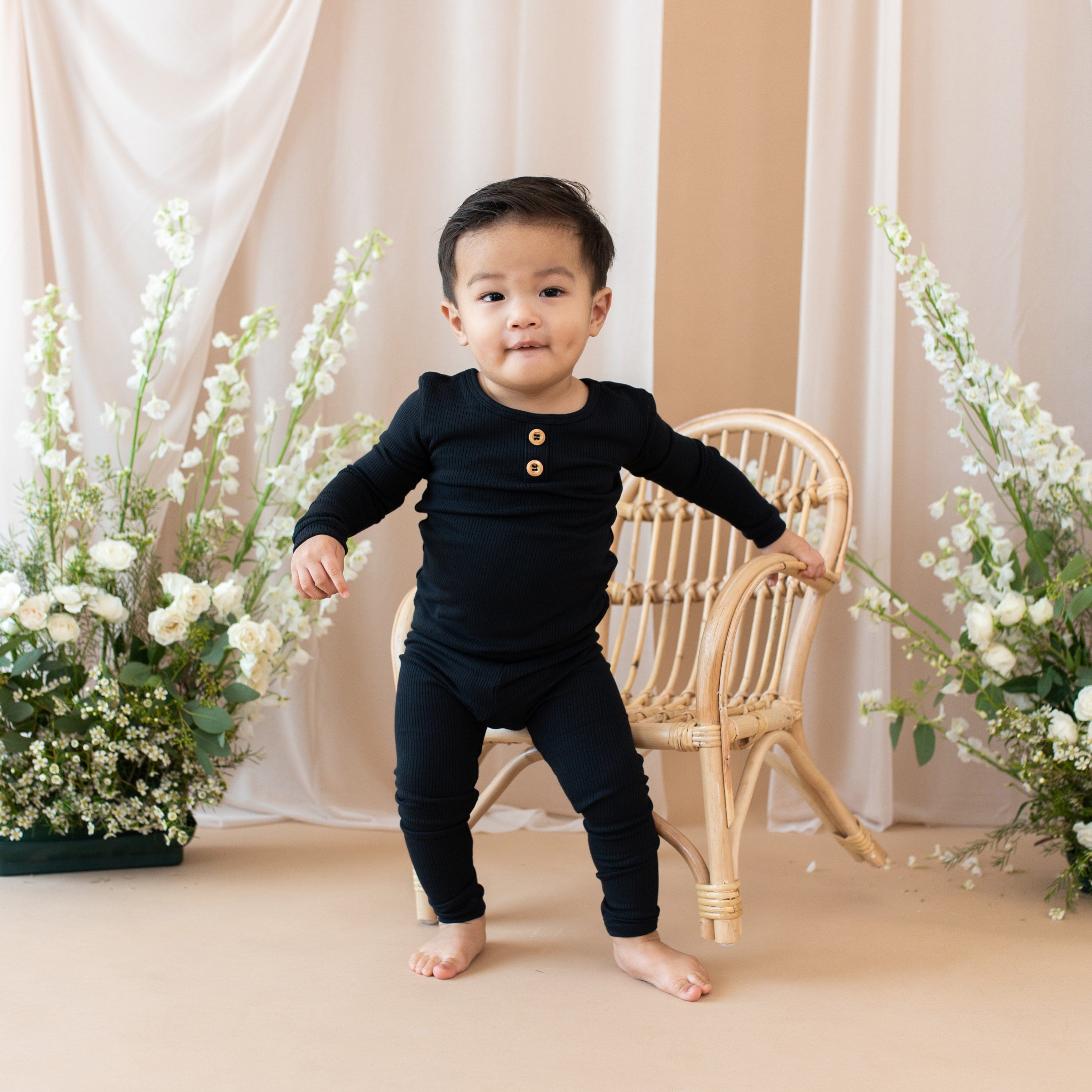 Toddler wearing Kyte Baby bamboo Ribbed Henley Set in Midnight black