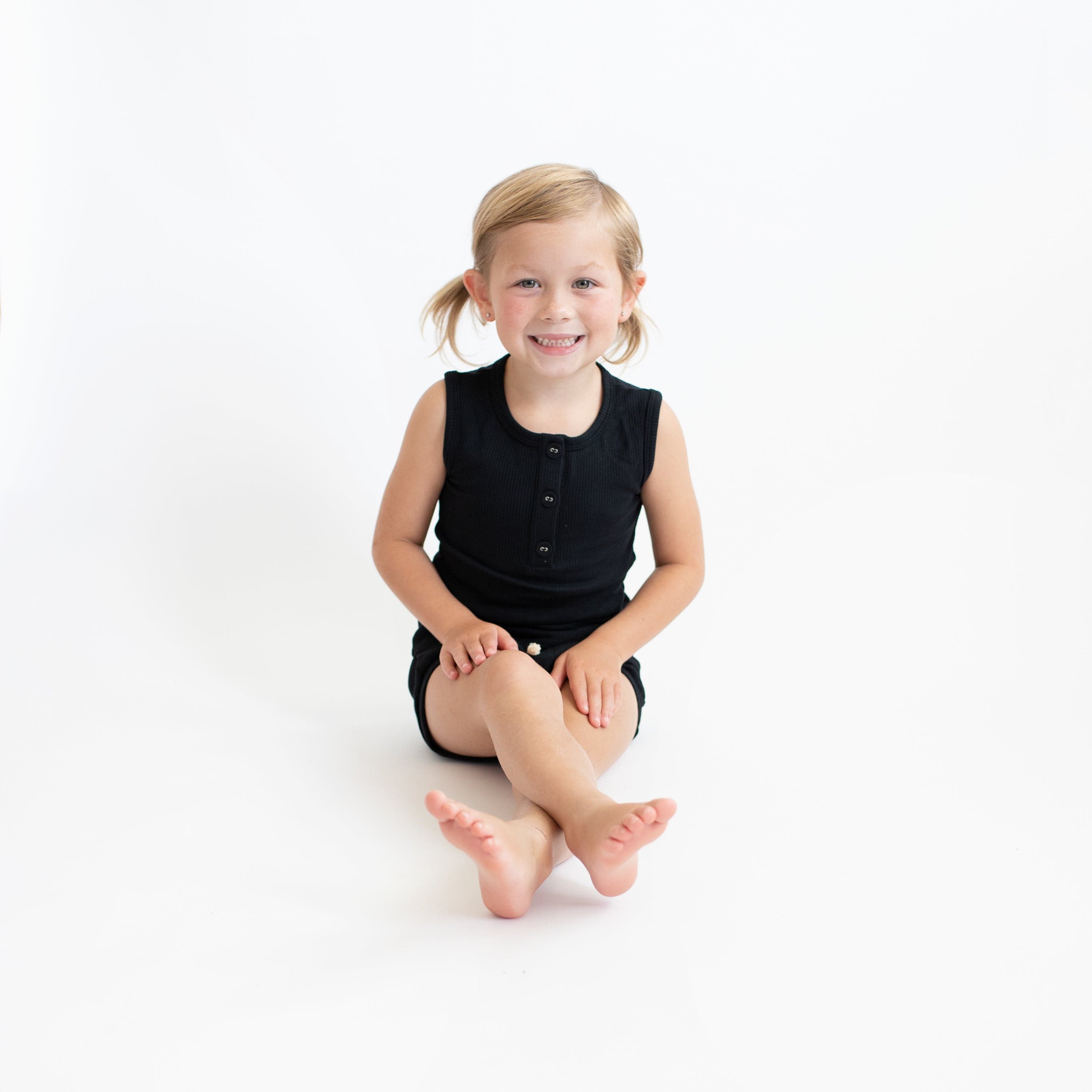 Girl wearing Kyte Baby bamboo Ribbed Henley Tank and Shorts Set in Midnight