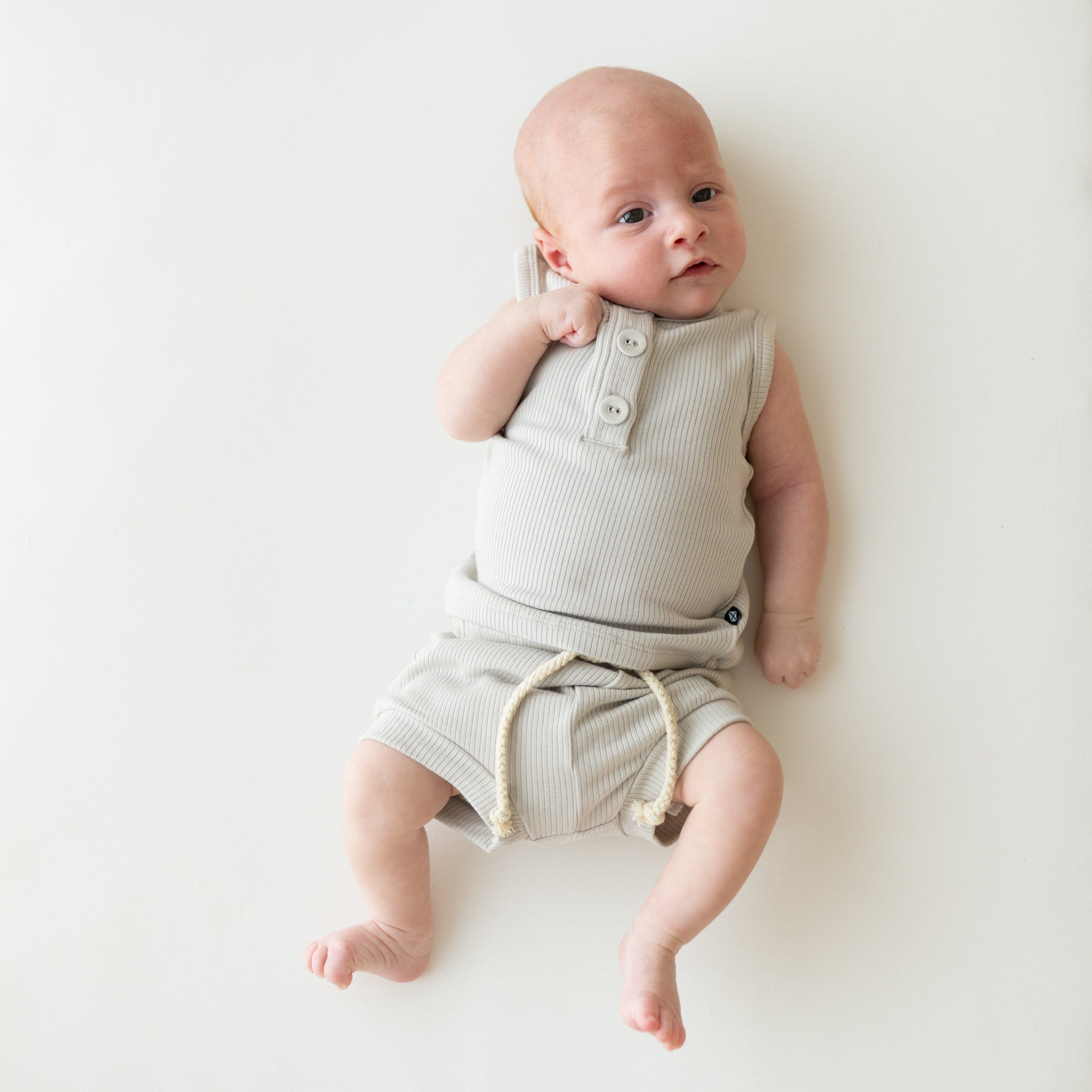 Infant wearing Kyte Baby Ribbed Henley Tank Set in Oat