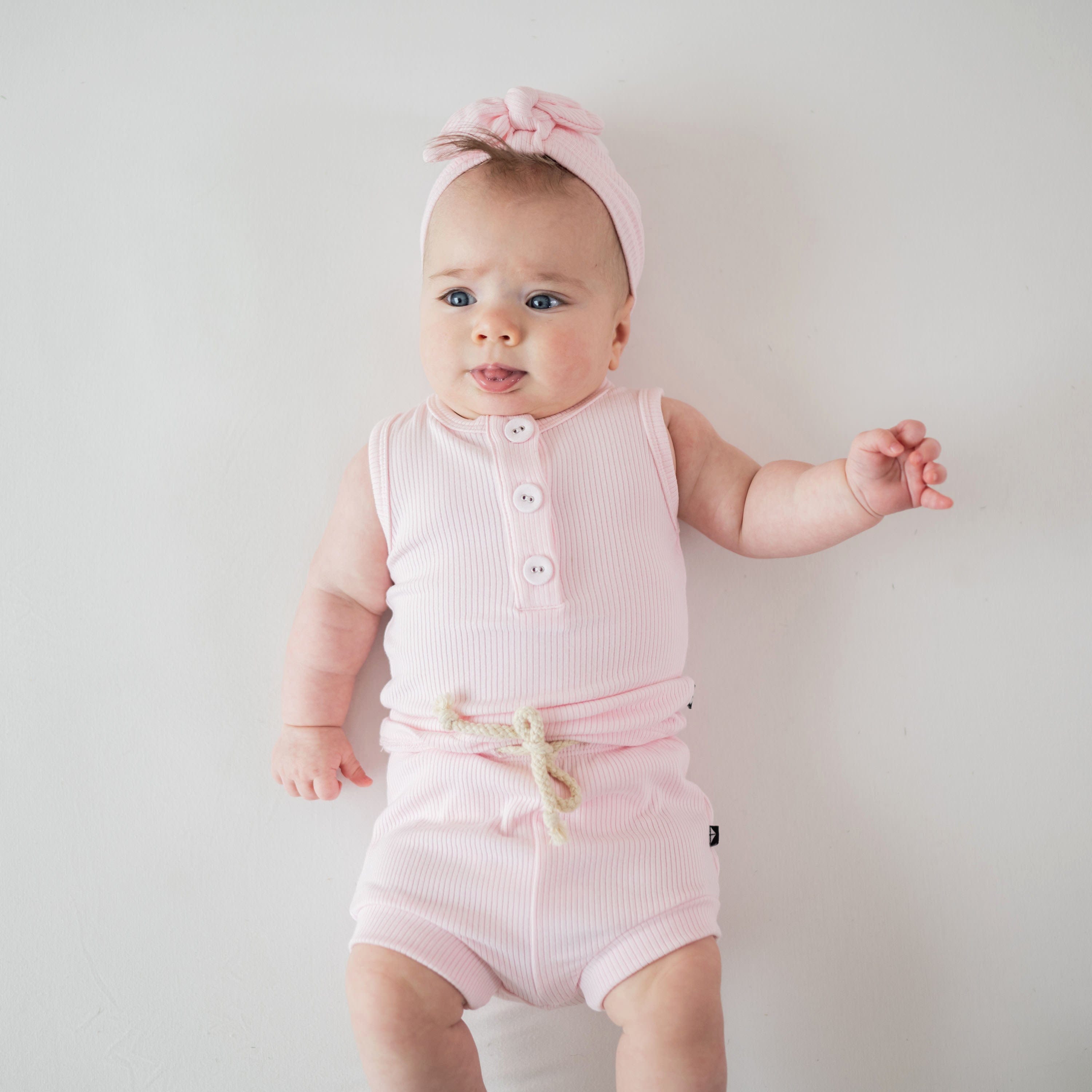 Infant wearing Kyte Baby Ribbed Henley Tank Set in Sakura