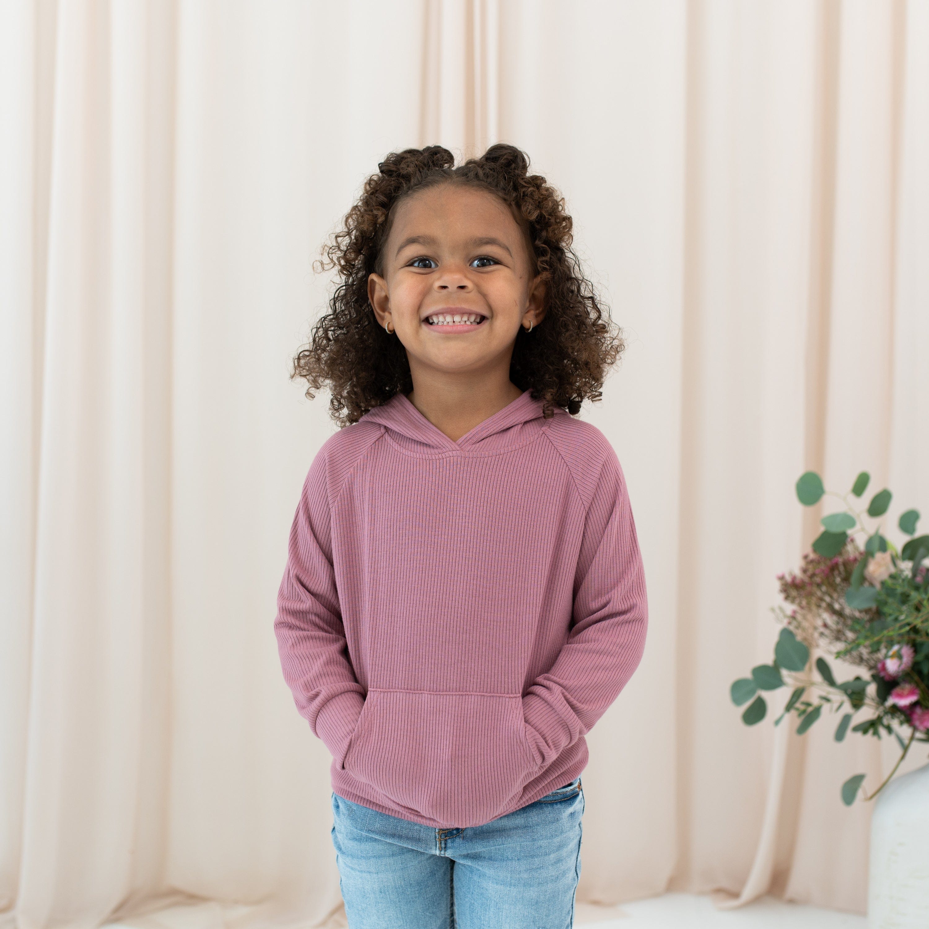 Girl wearing Kyte Baby Ribbed Hoodie in Dusty Rose