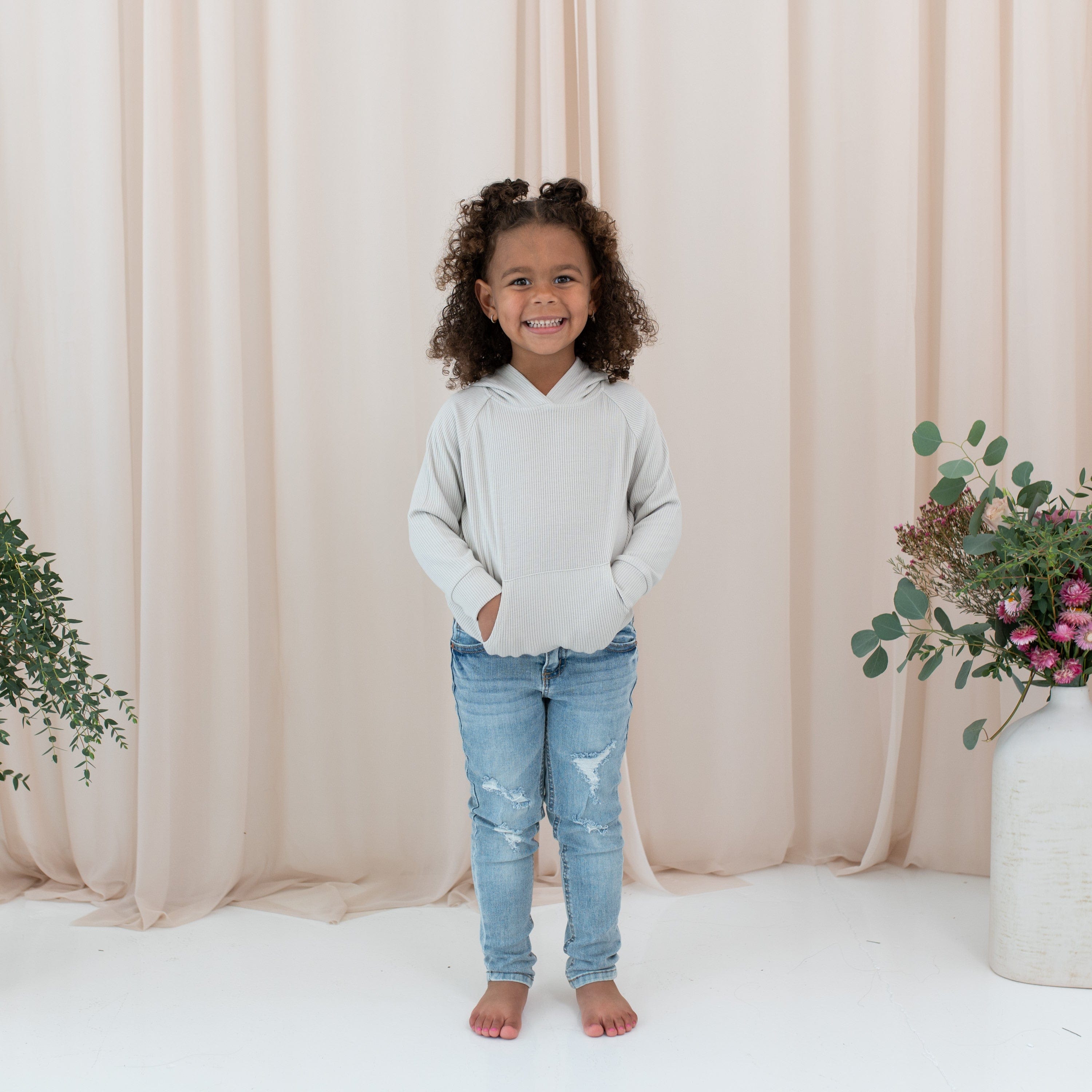 Girl wearing Kyte Baby Ribbed Hoodie in Oat