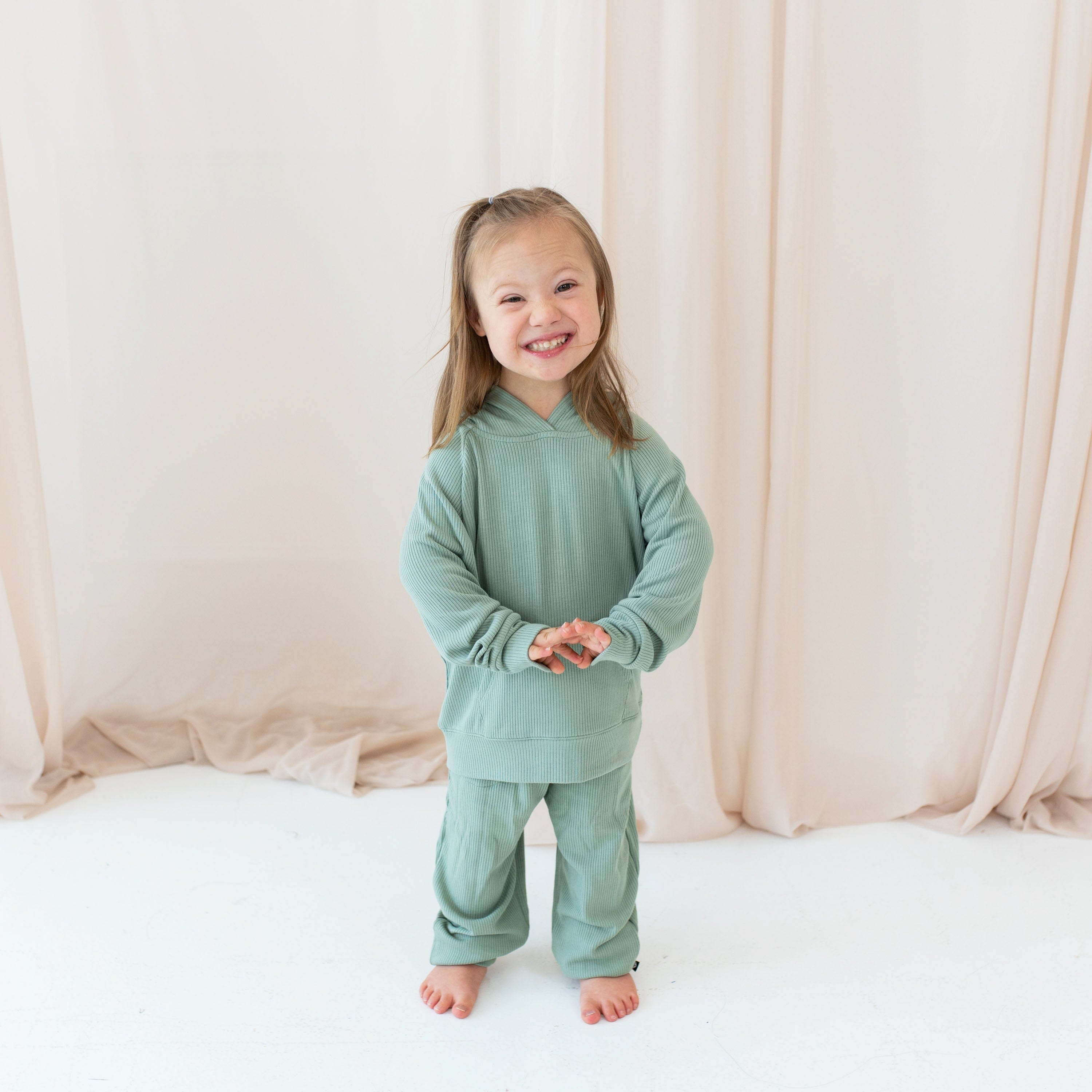 Toddler wearing Kyte Baby Ribbed Hoodie and Jogger Pant in Thyme green