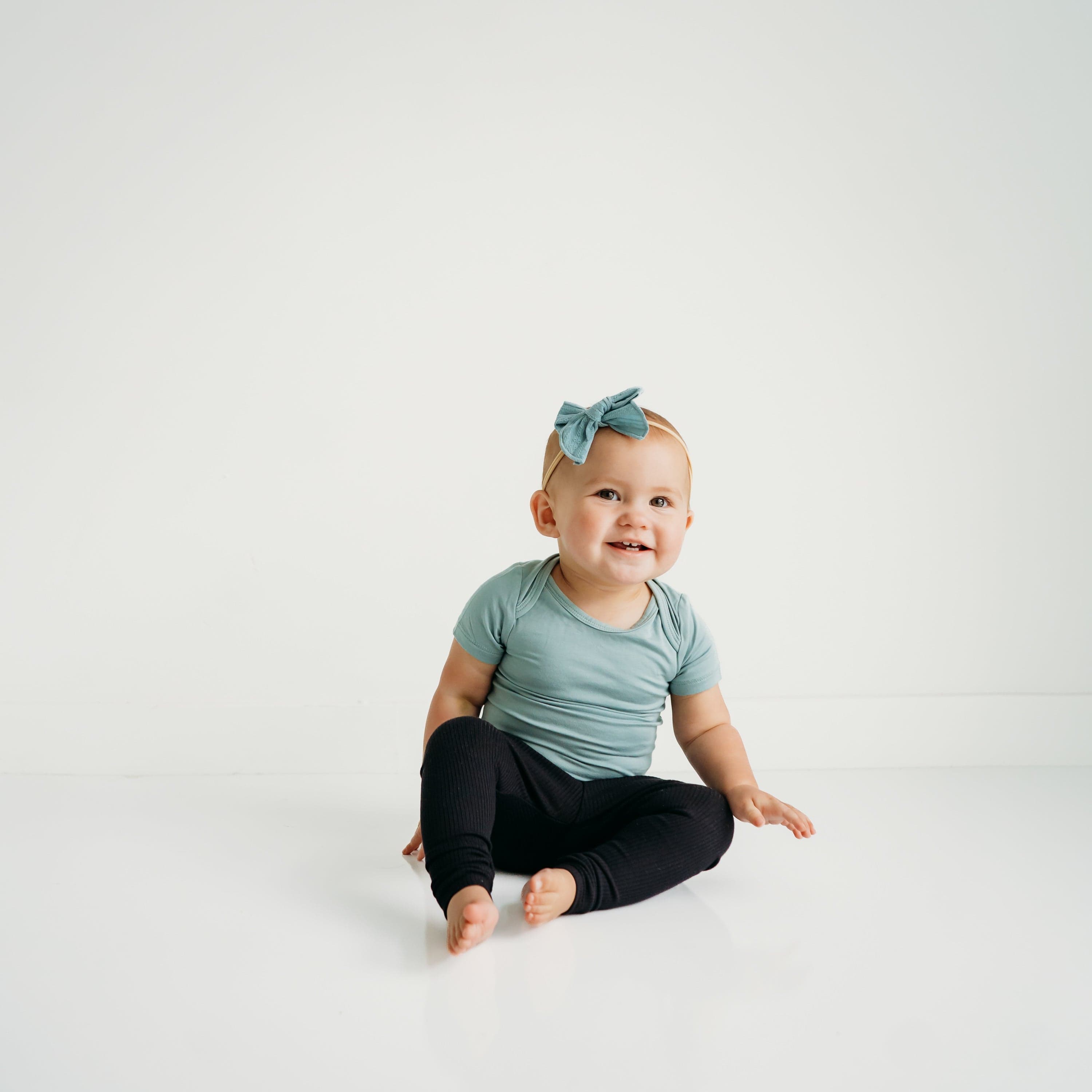 Infant Wearing Kyte Baby Ribbed Leggings in Midnight