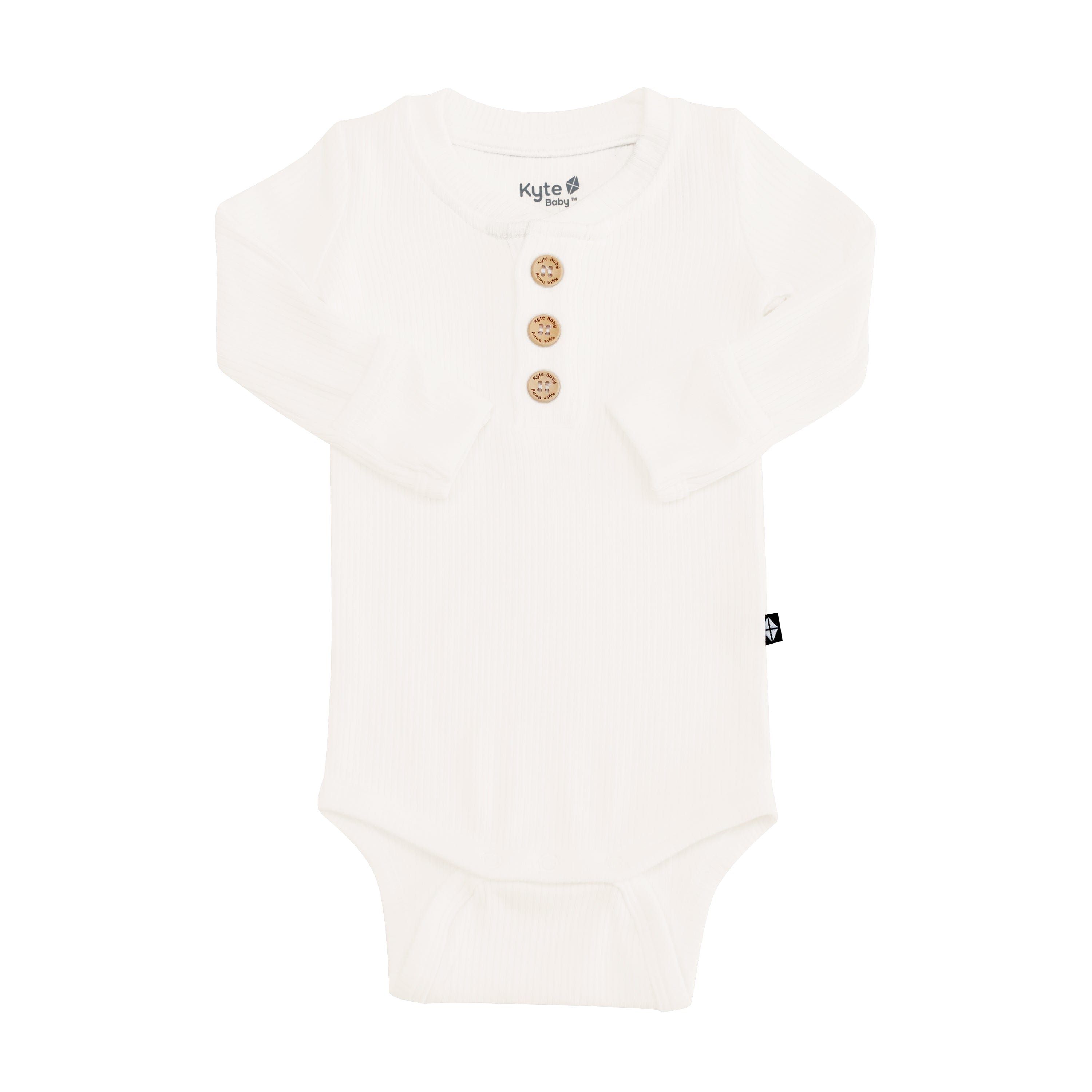 Kyte Baby Ribbed Long Sleeve Henley Bodysuit with wooden buttons in Cloud. Sleeves are folded inwards.
