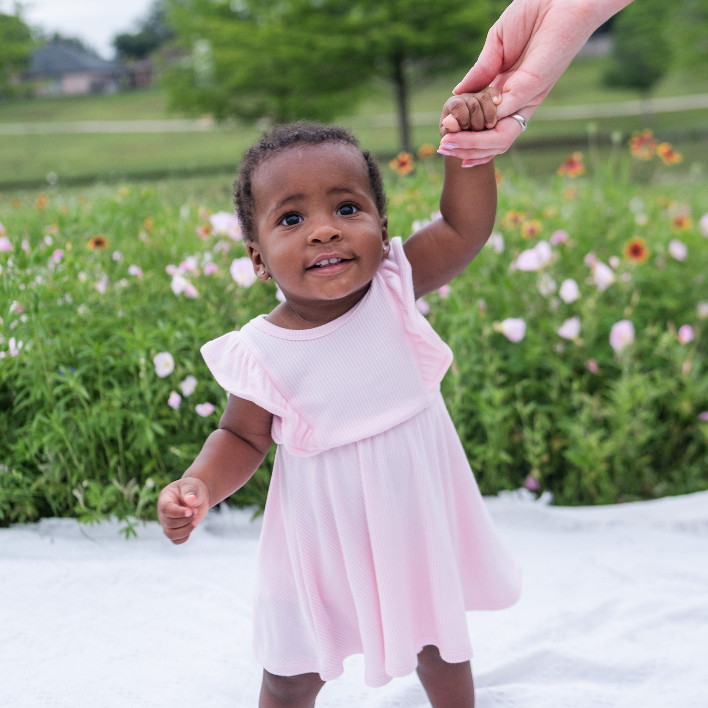 Infant wearing Kyte Baby Ribbed Peplum Dress Set in Sakura pink