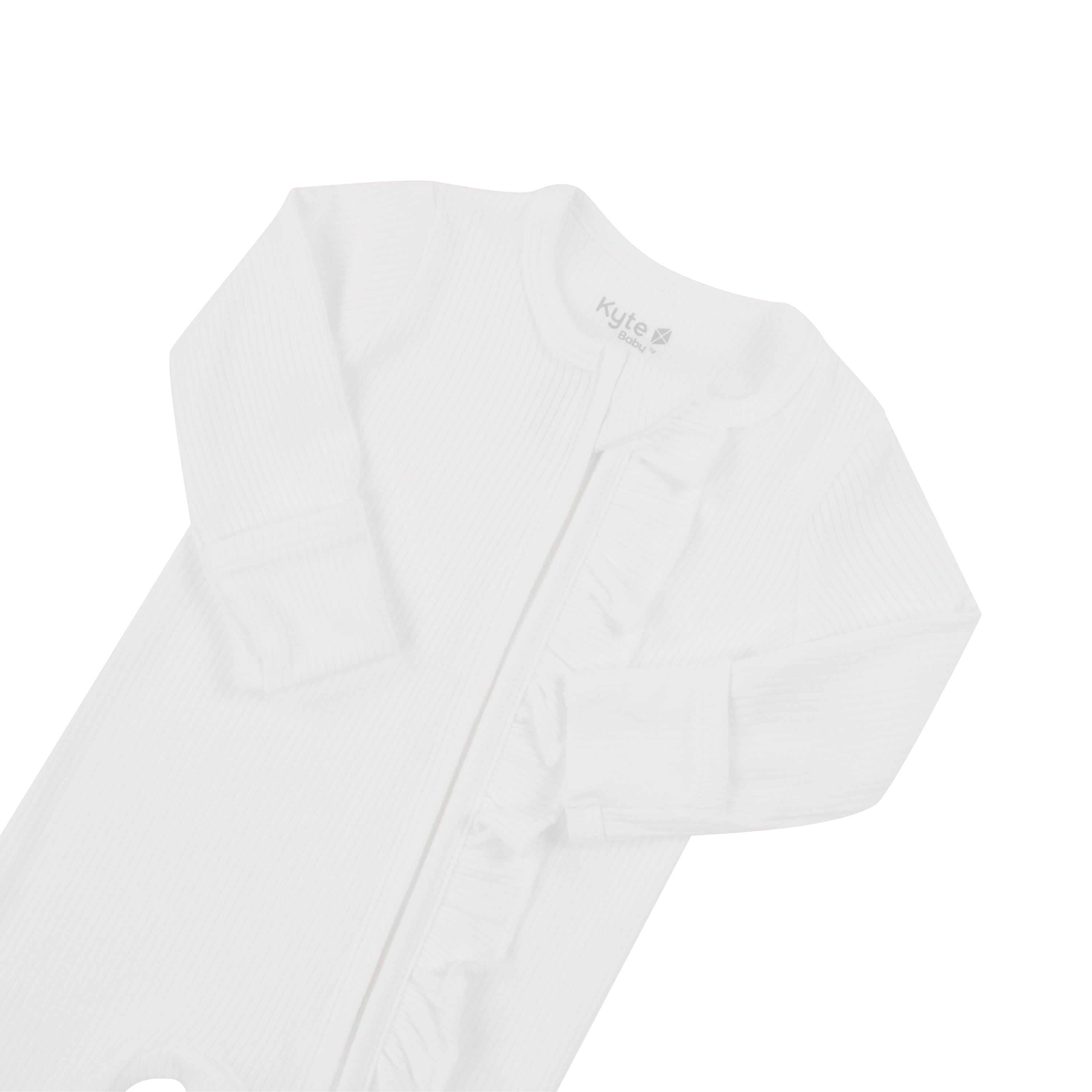 Flat lay displaying fold over cuffs on Kyte Baby Ribbed Ruffle Zipper Footie in Cloud