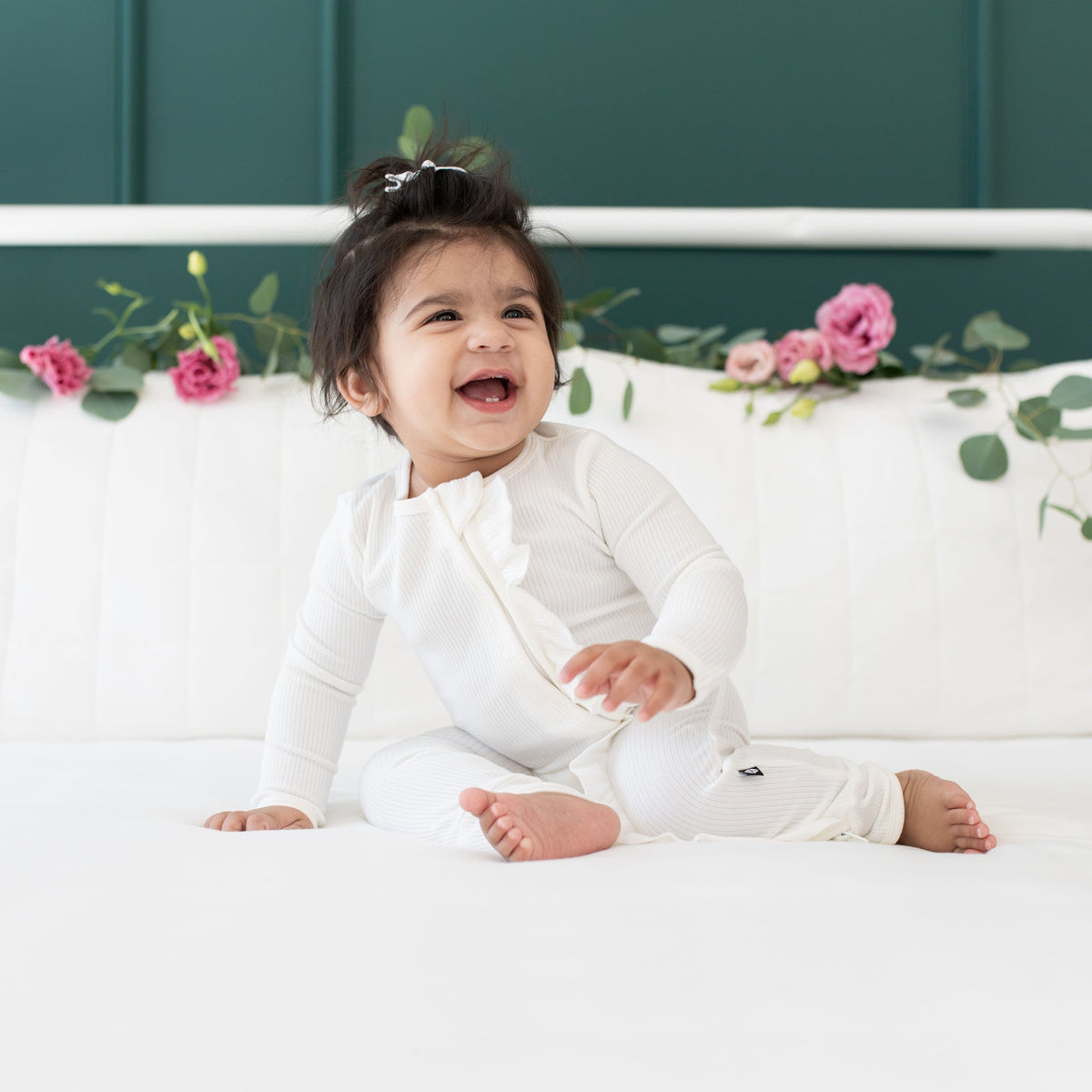 Toddler wearing Kyte Baby Ribbed Ruffle Zipper Romper in Cloud