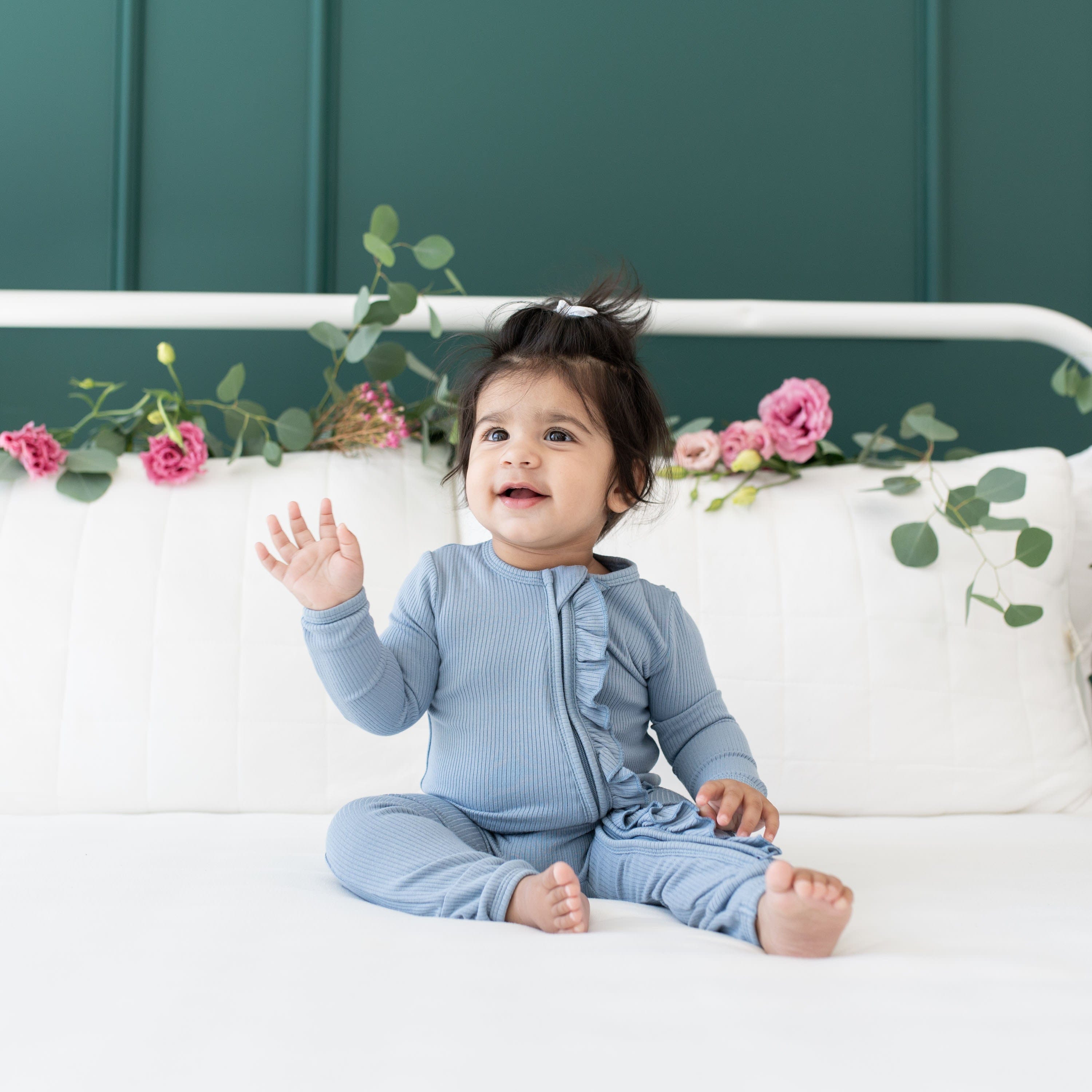 Toddler wearing Kyte Baby Ribbed Ruffle Zipper Romper in Slate