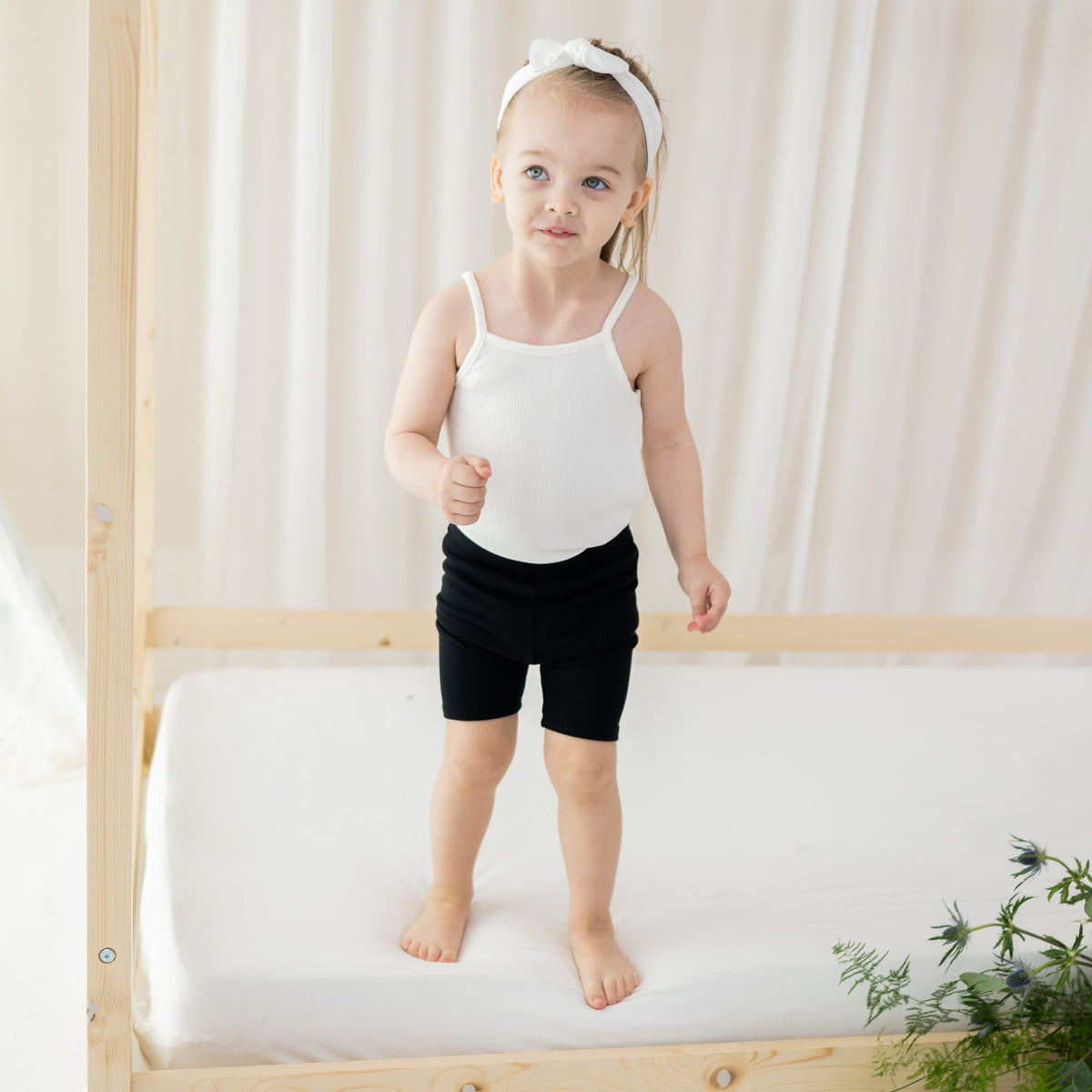 Toddler wearing Kyte Baby Ribbed
Spaghetti Strap Bodysuit in Cloud