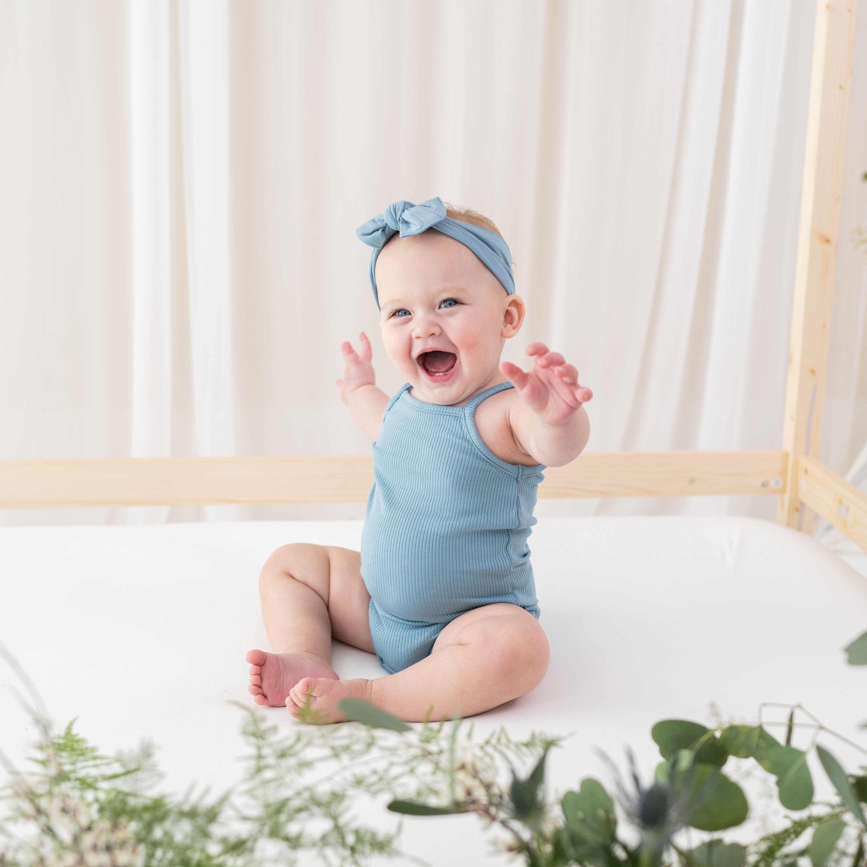 Child wearing Kyte Baby bamboo Ribbed Spaghetti Strap Bodysuit in Dusty Blue