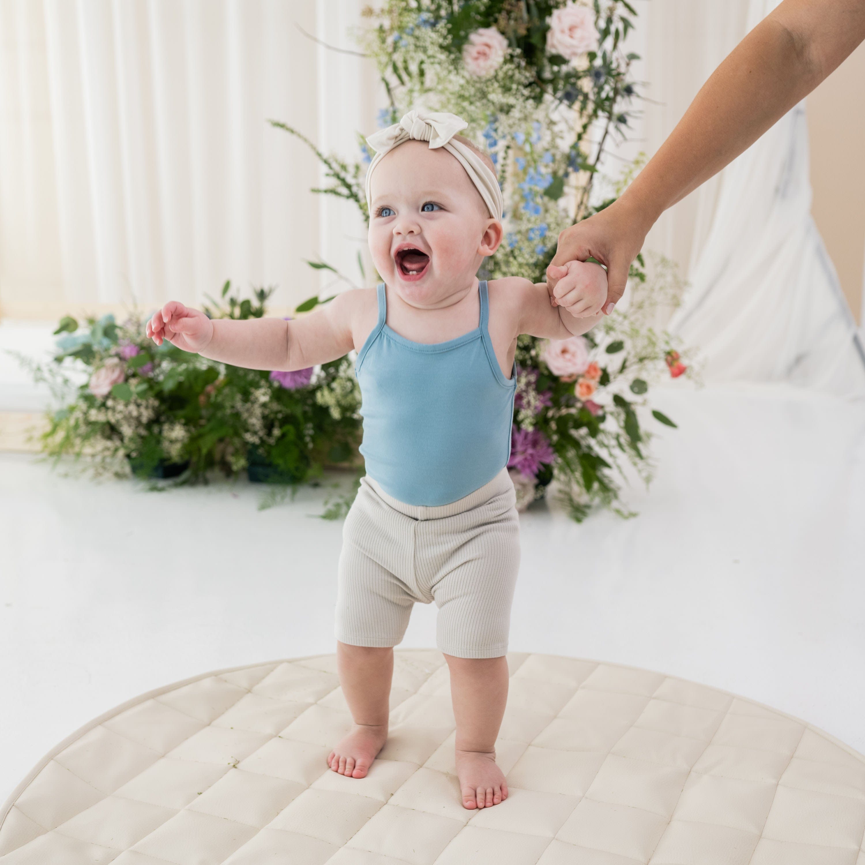 Infant wearing Kyte Baby Ribbed Biker Shorts in Oat