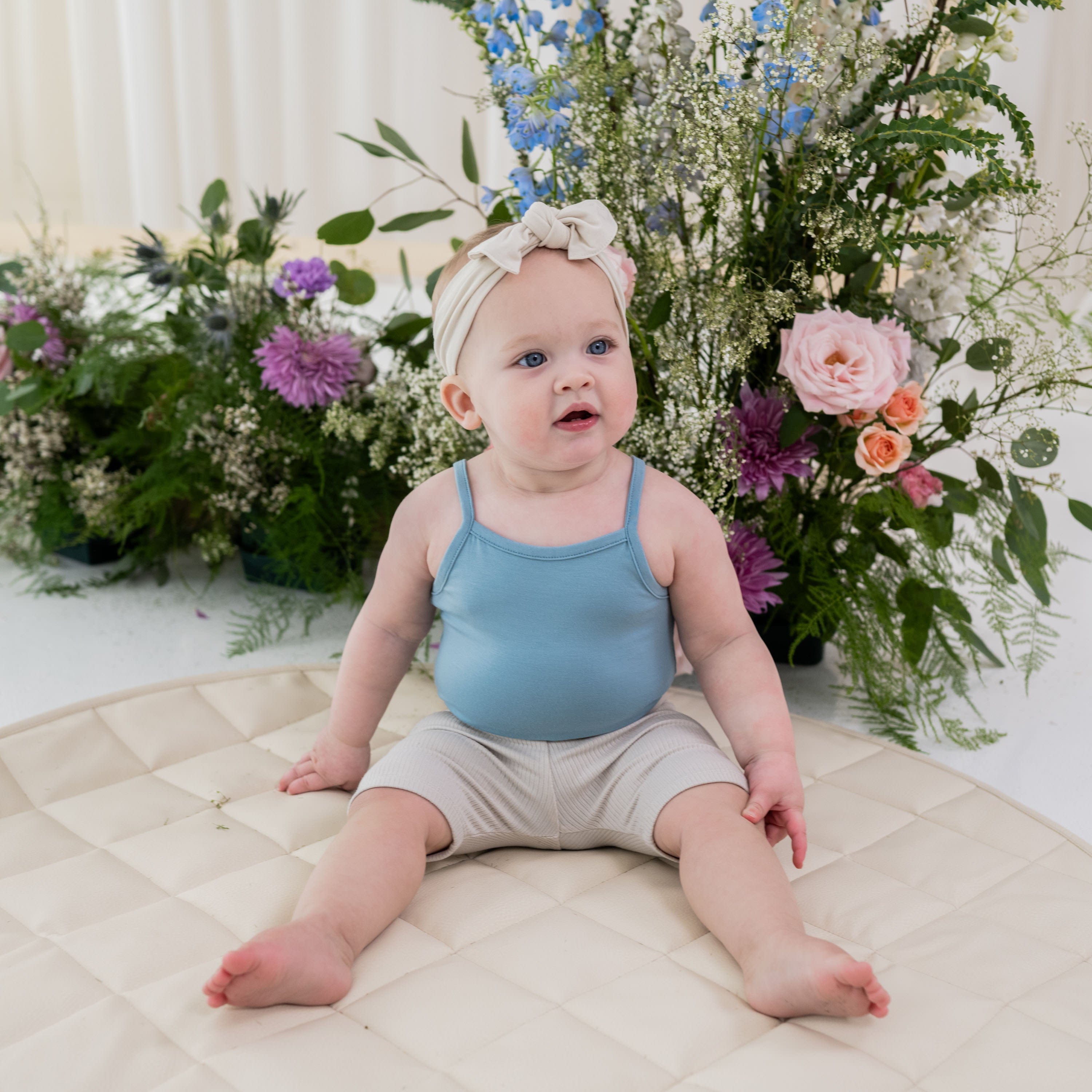 Child wearing Kyte Baby Bamboo Ribbed Toddler Biker Shorts in Oat