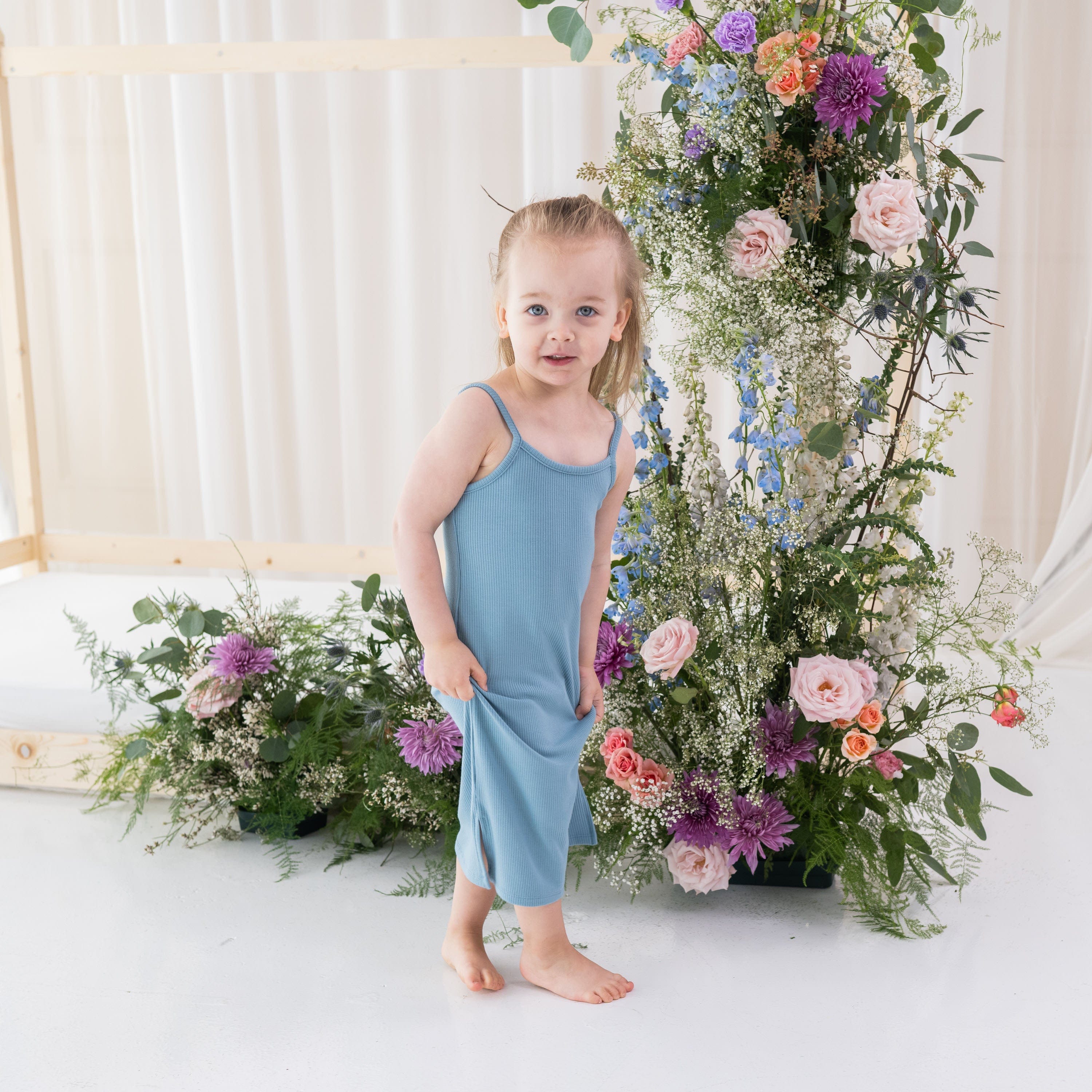Girl wearing Kyte Baby Ribbed Toddler Cami Dress in Dusty Blue