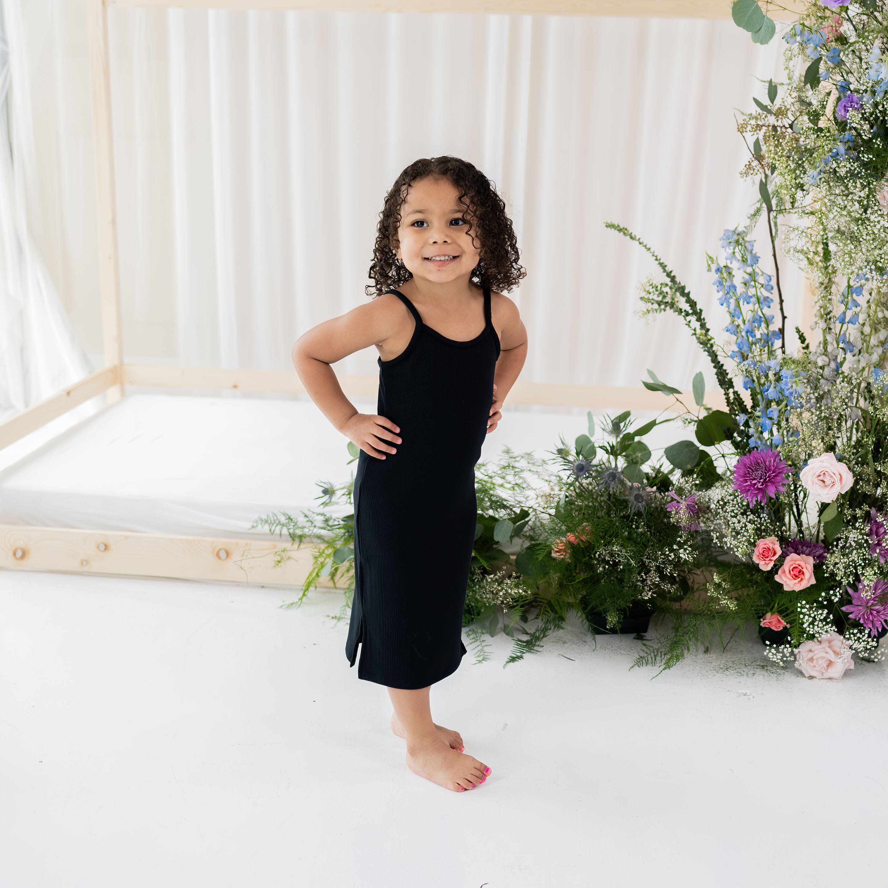 Girl wearing Kyte Baby Ribbed Toddler Cami Dress in Midnight