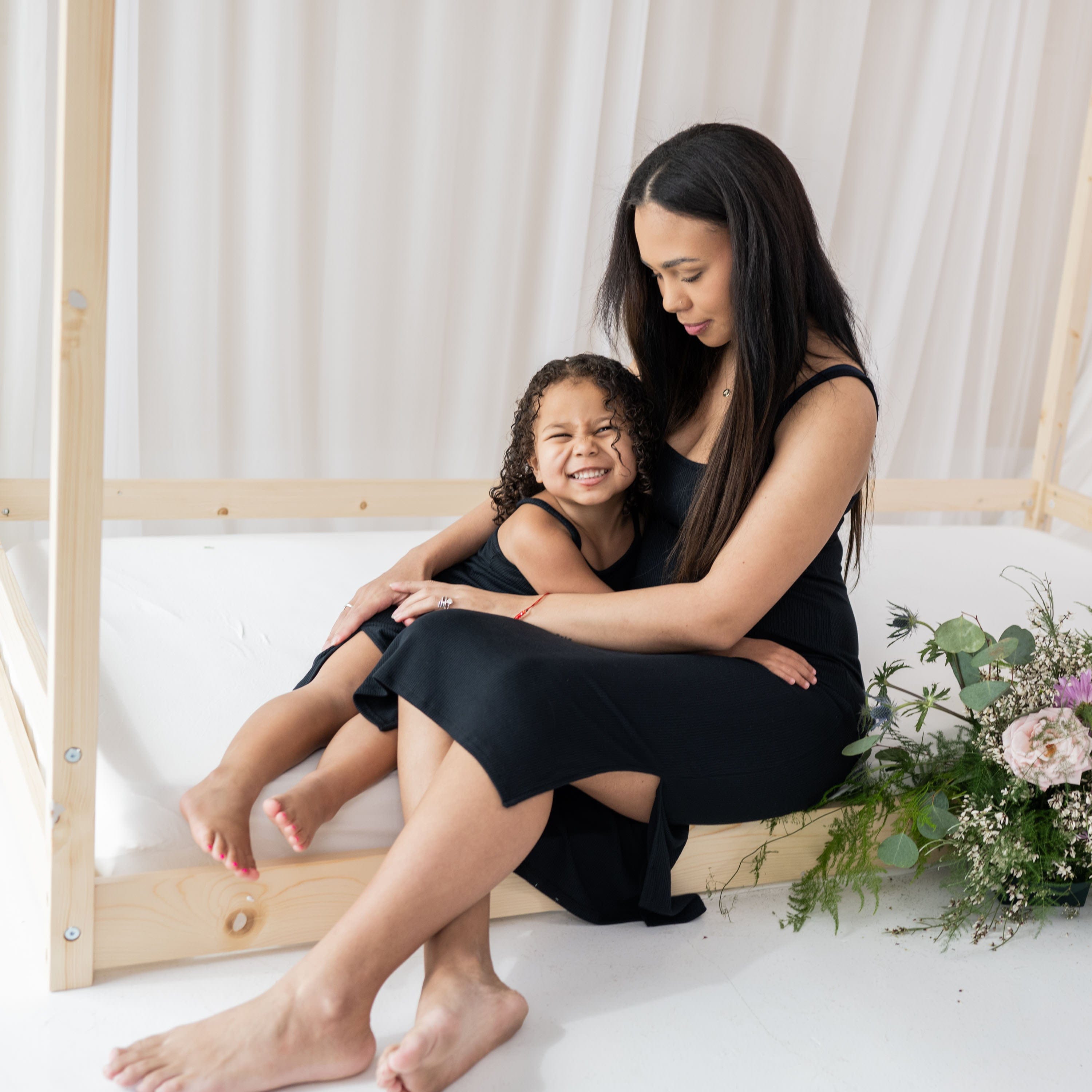 Models wearing Kyte Baby mommy and me dresses in Midnight