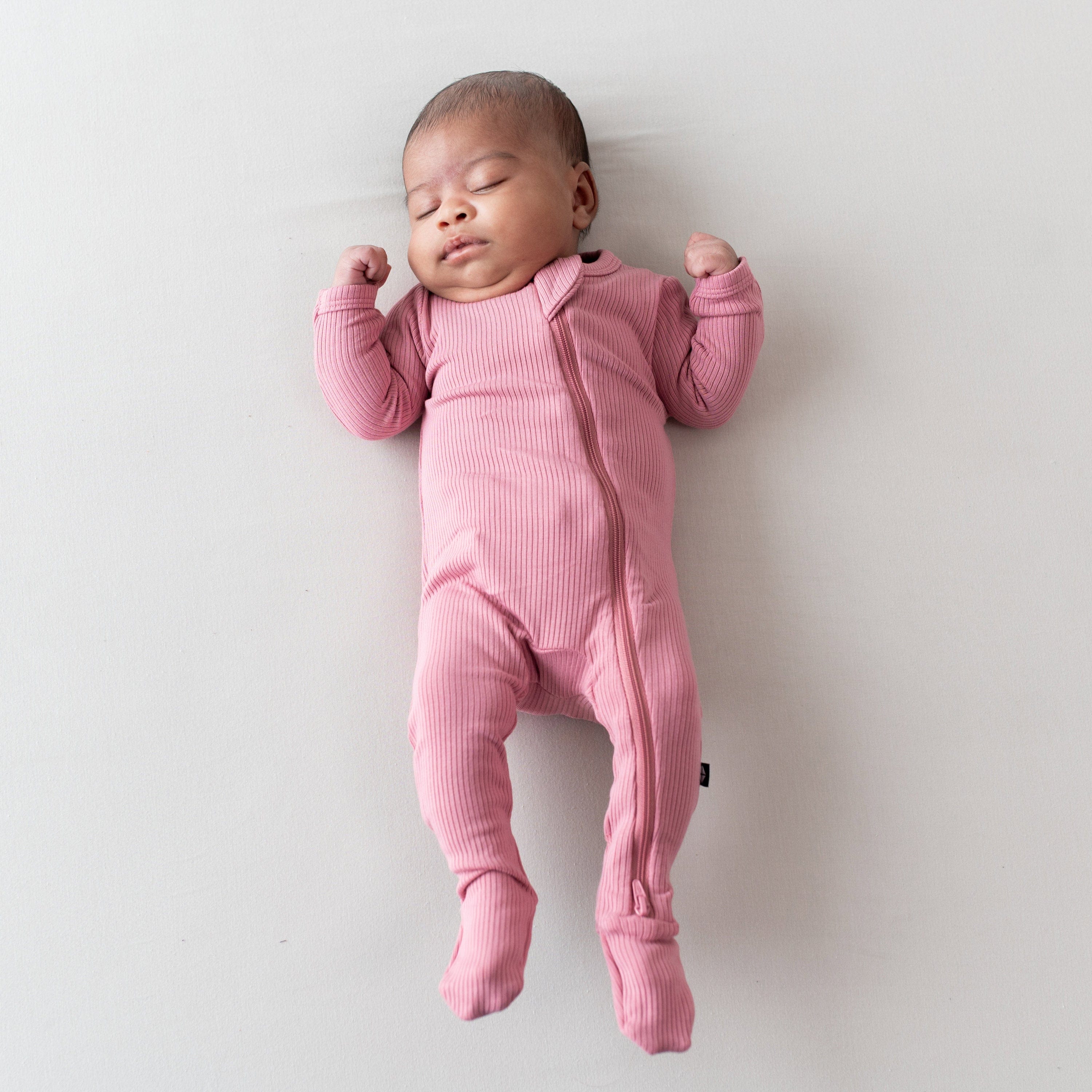 Newborn wearing Ribbed Zipper Footie Pajamas in Apple Blossom
