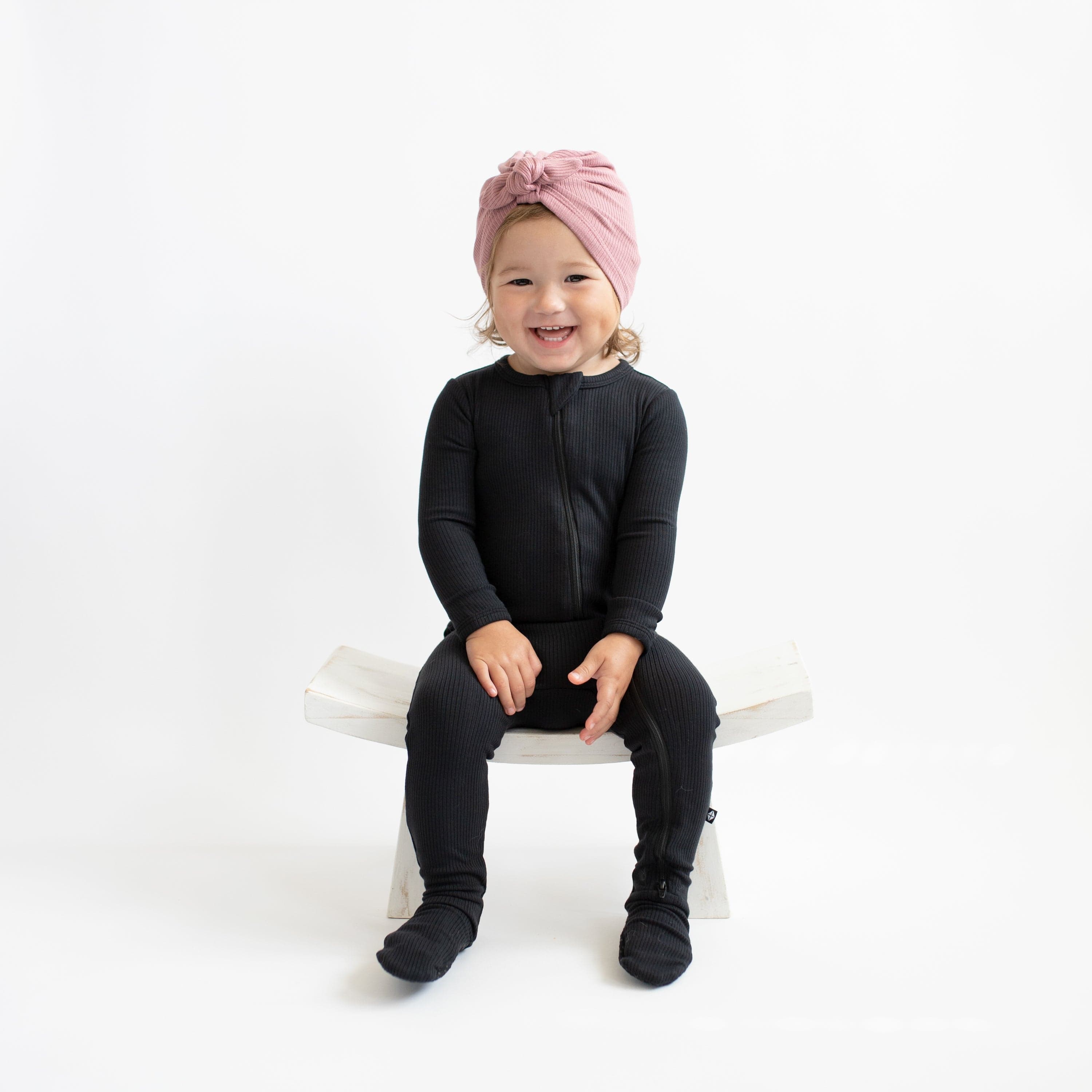 Toddler wearing Kyte Baby Ribbed Zippered Footie in Midnight