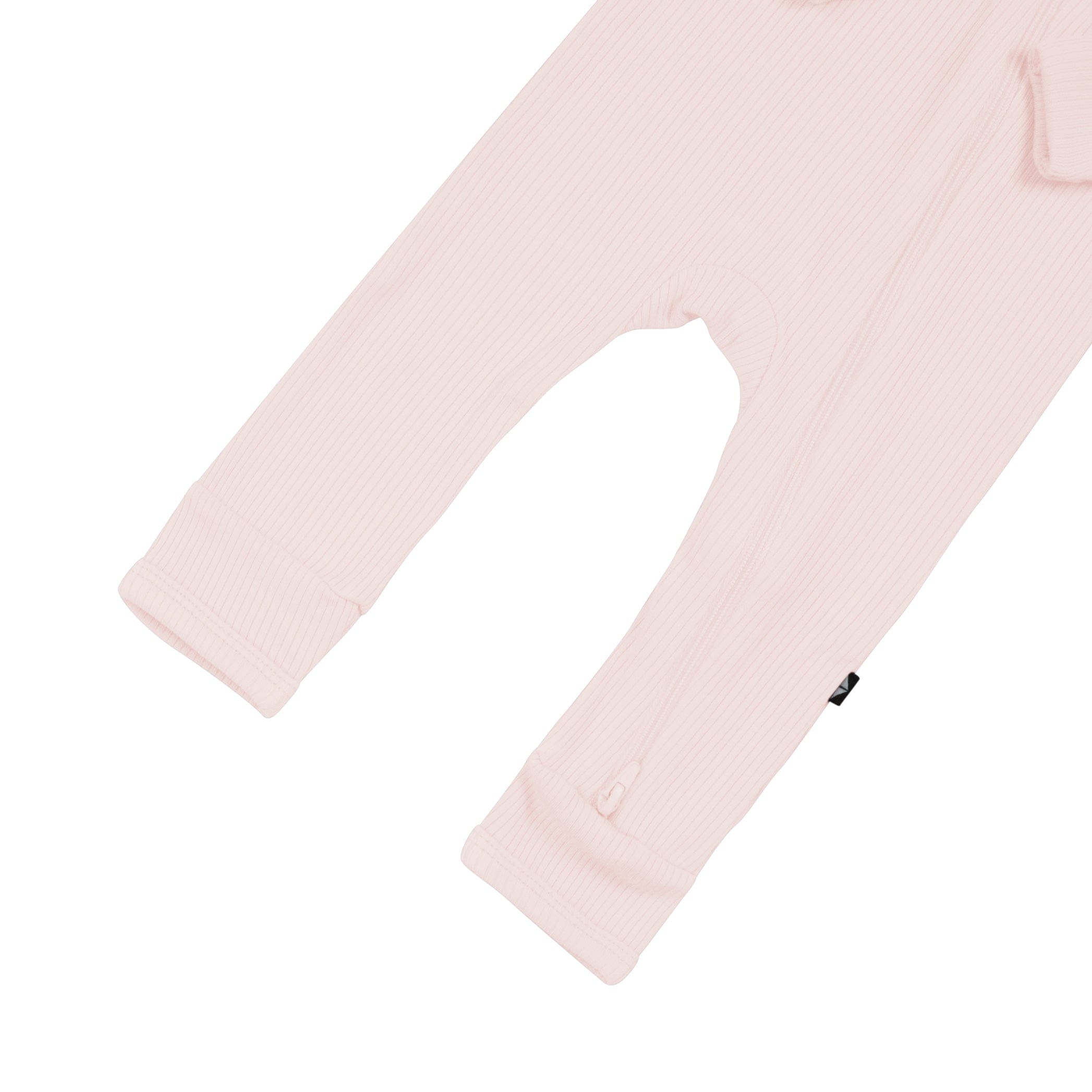Open feet on Kyte Baby Ribbed Zippered Romper in Blush