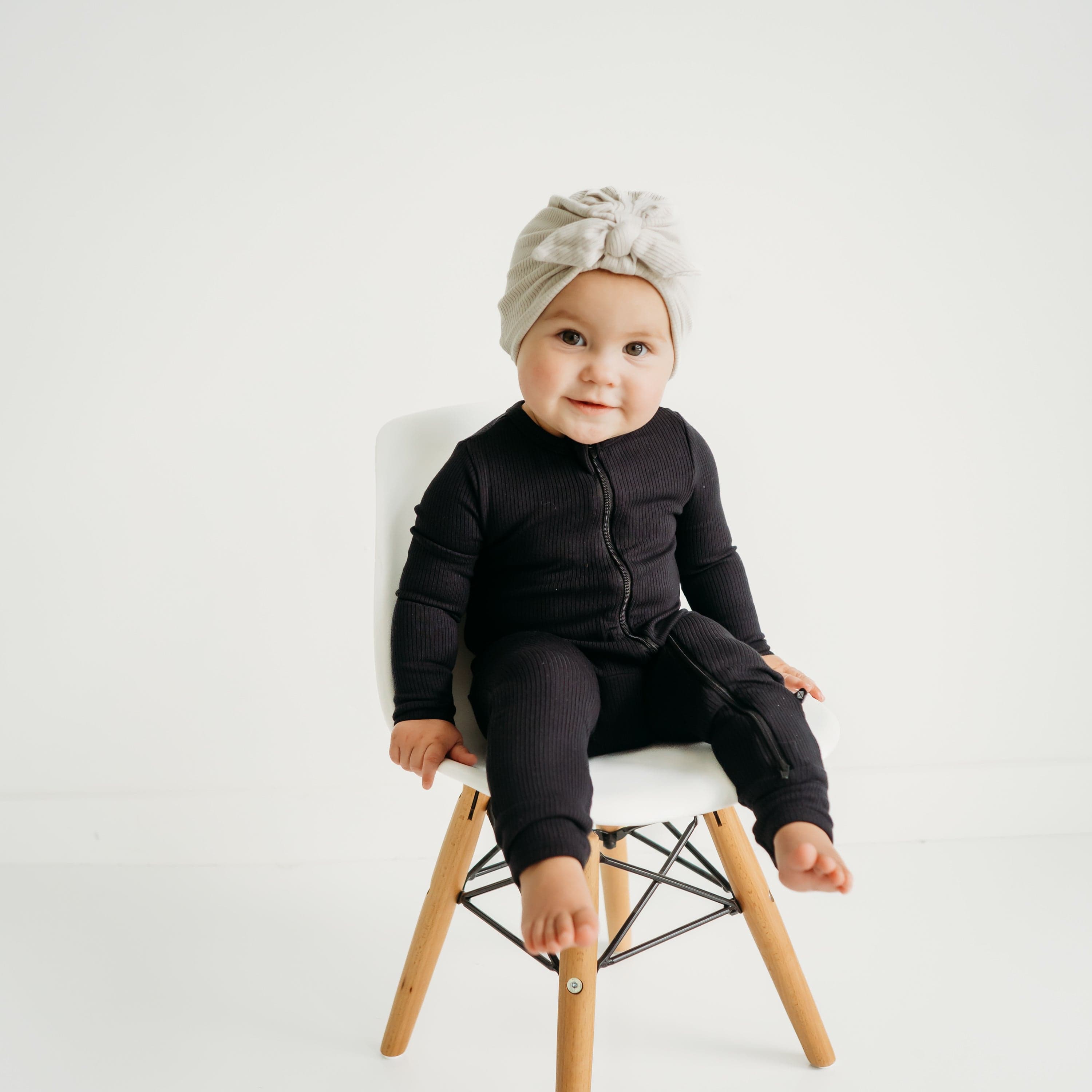 Baby wearing Kyte Baby Ribbed Zippered Romper in Midnight