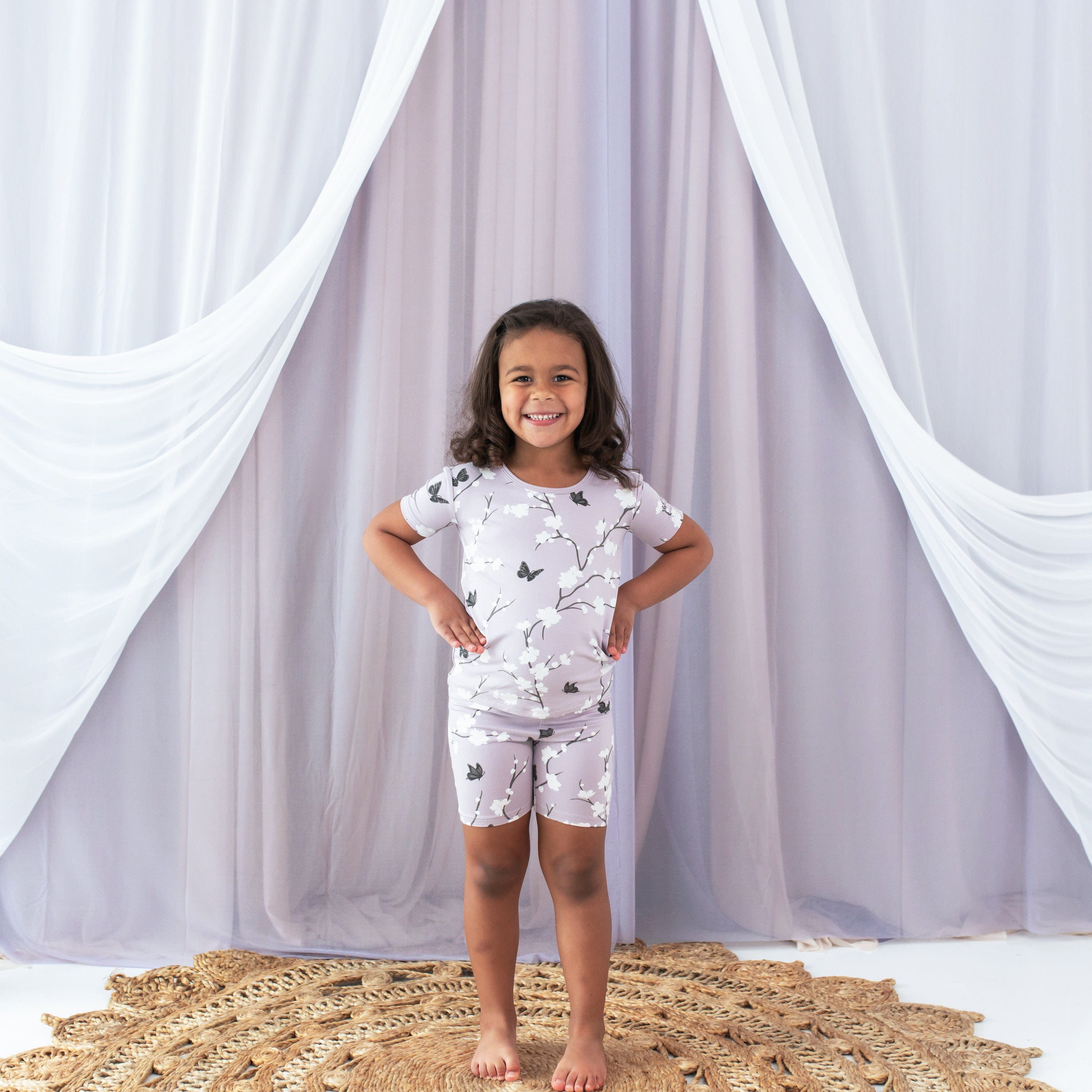 Child wearing Kyte Baby Short Sleeve Pajamas in Cherry Blossom