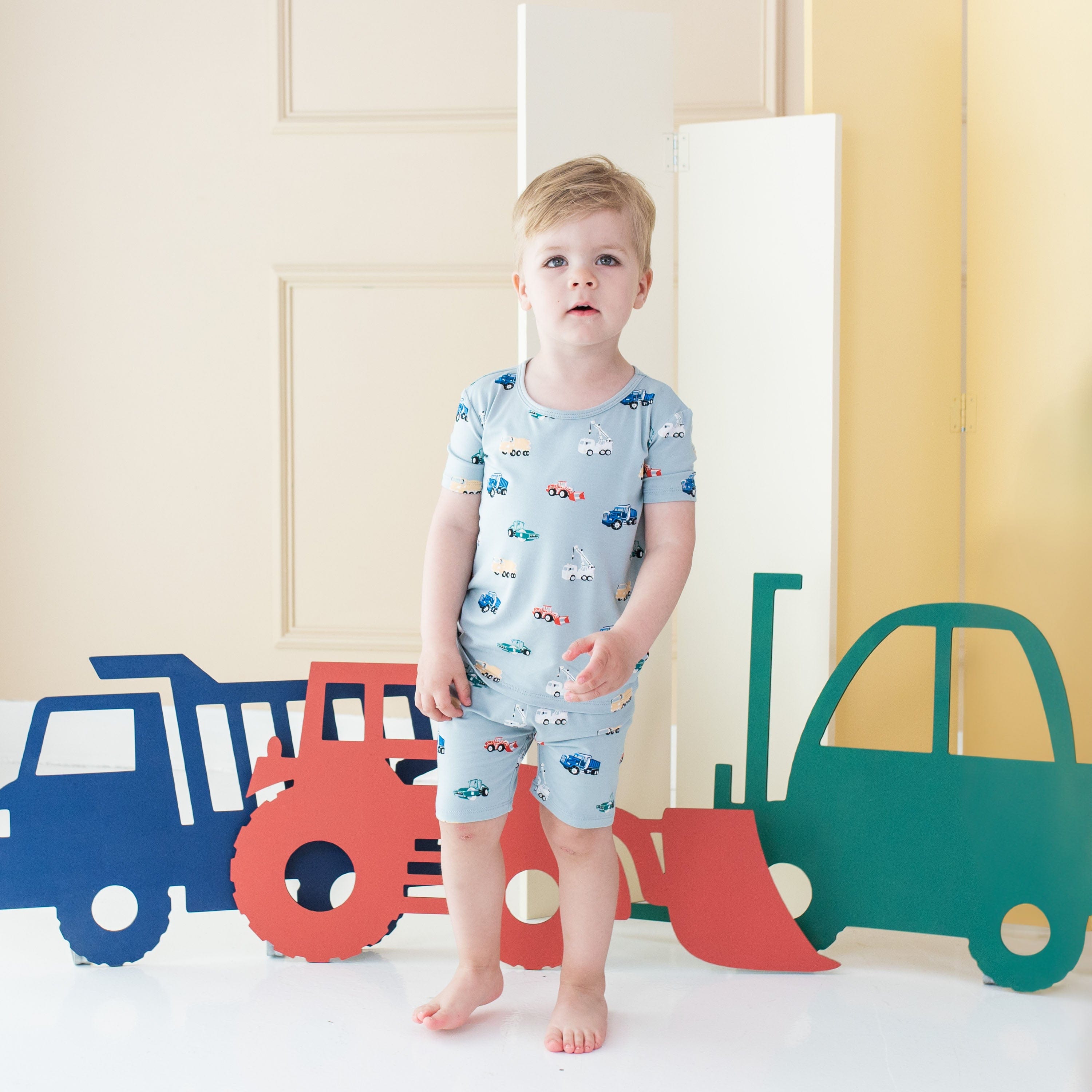 Child wearing Kyte Baby Short Sleeve Pajamas in Construction