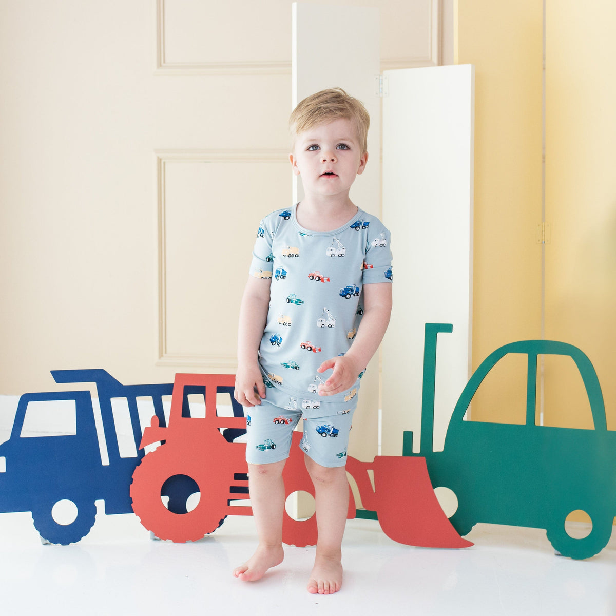Child wearing Kyte Baby Short Sleeve Pajamas in Construction