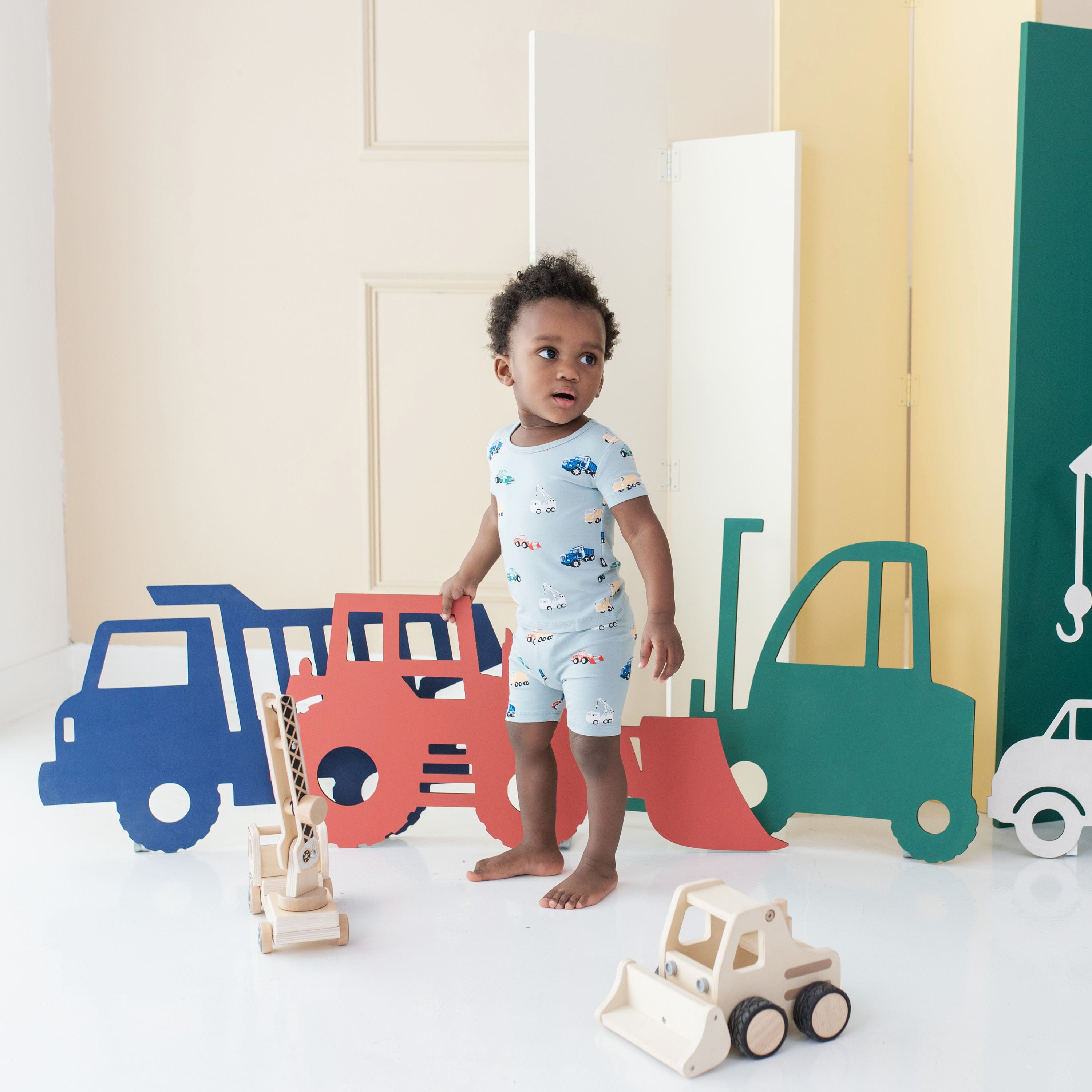 Toddler wearing Kyte Baby Short Sleeve Pajama Set in Construction