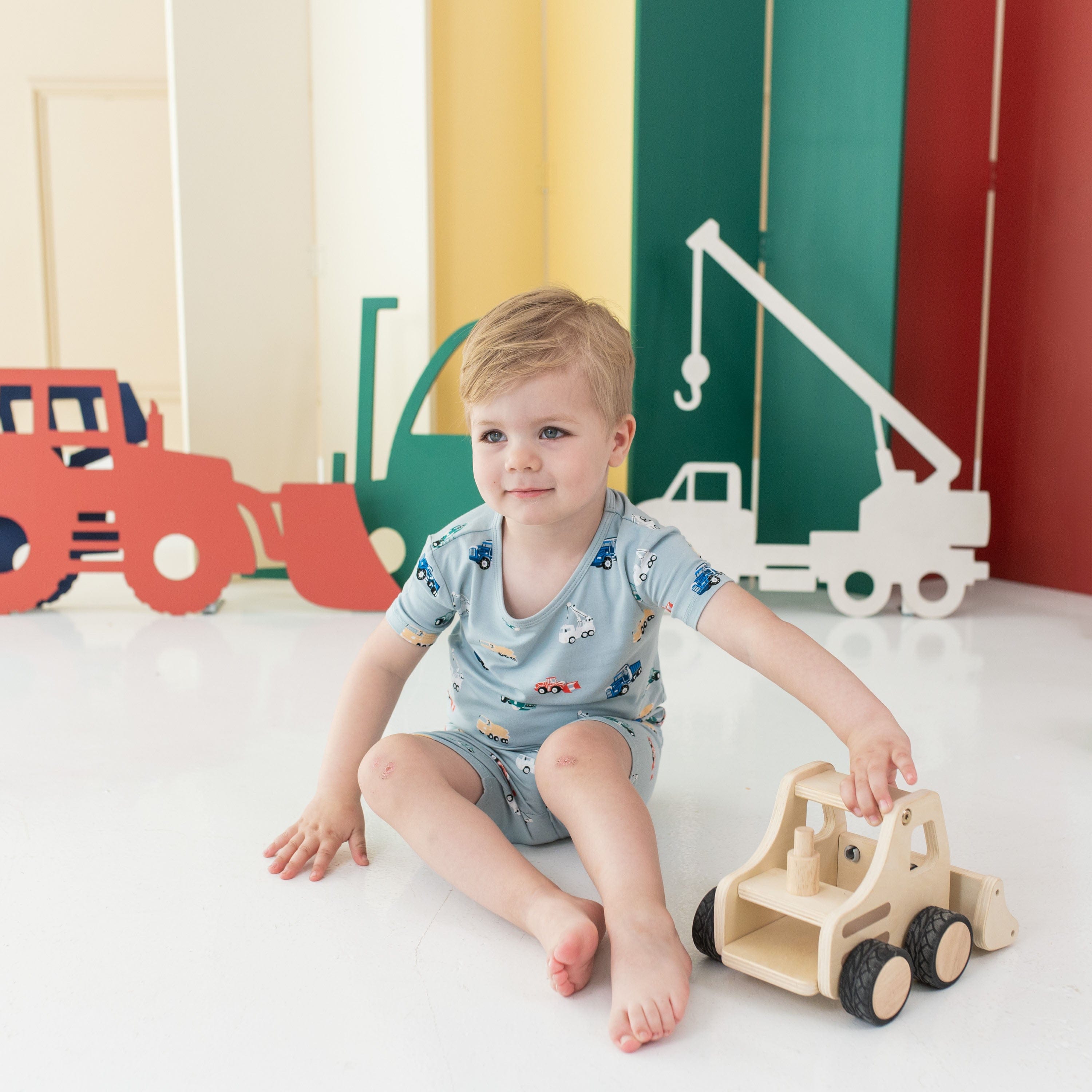 Boy wearing Kyte Baby bamboo Short Sleeve Pajamas in Construction